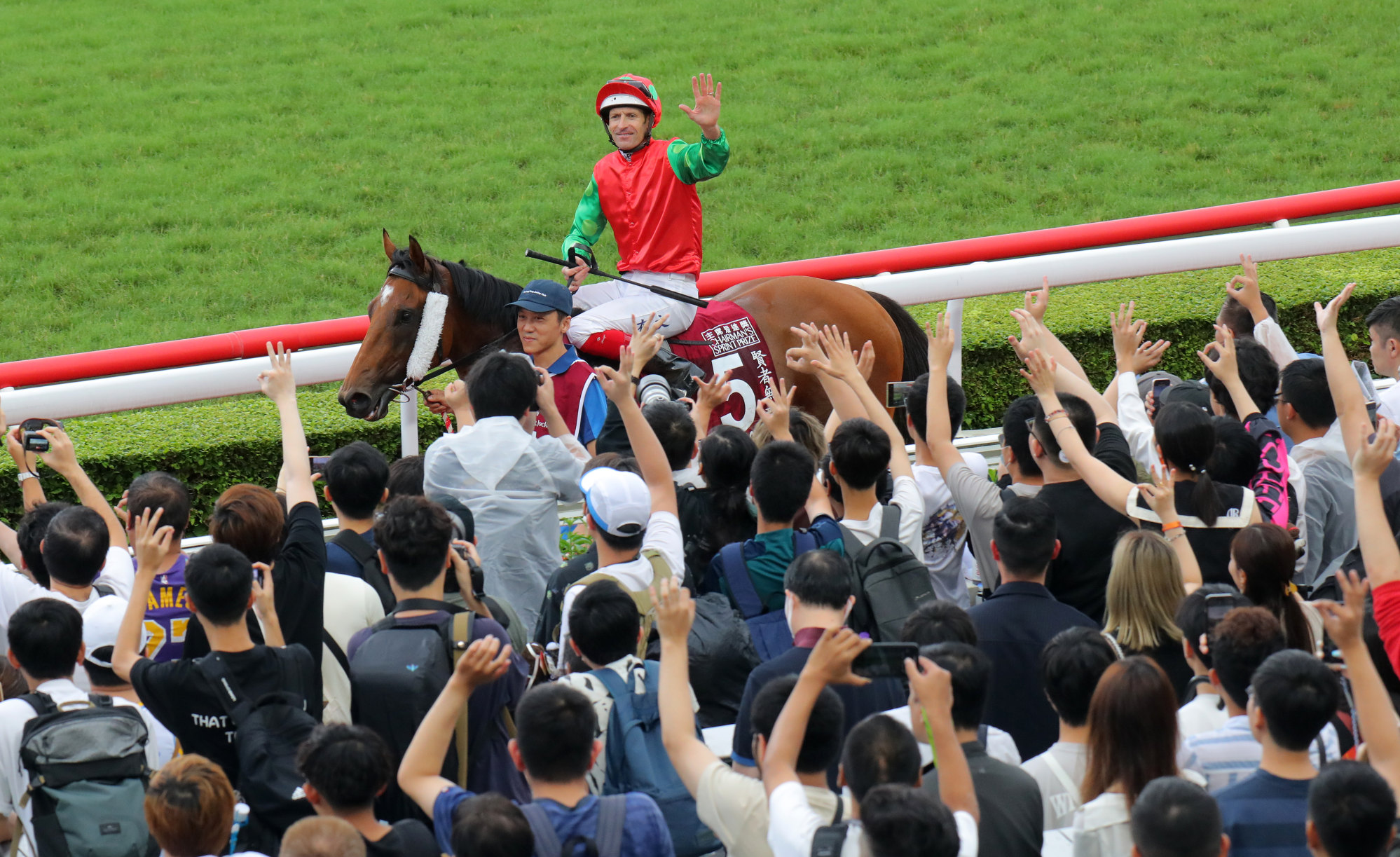 Hugh Bowman returns to the winner’s enclosure after guiding Invincible Sage to victory in the Chairman’s Sprint Prize.