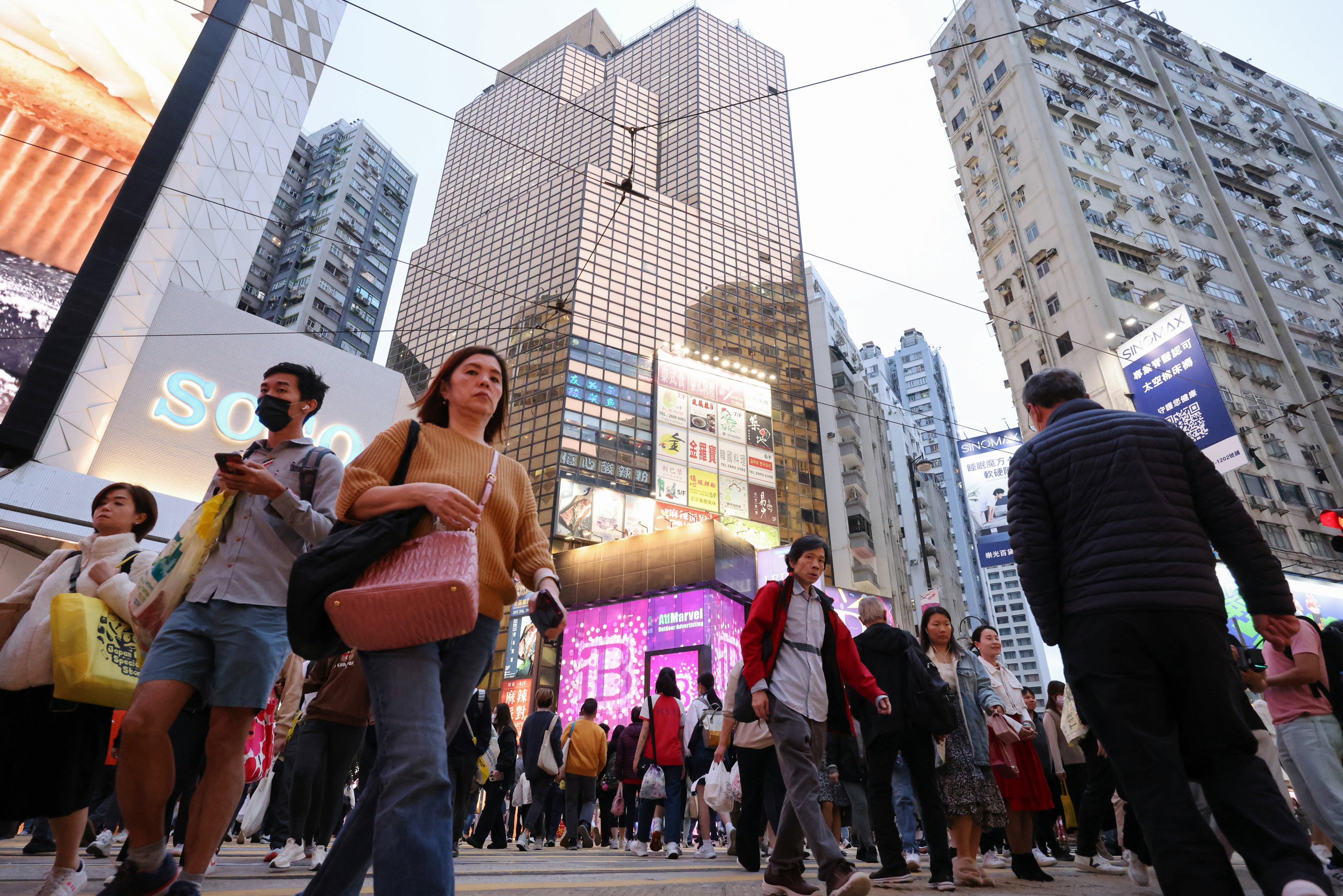 Pedestrians in Causeway Bay. A pilot visa scheme for mainland talent will also be expanded to cover Beijing and Shanghai residents. Photo: May Tse