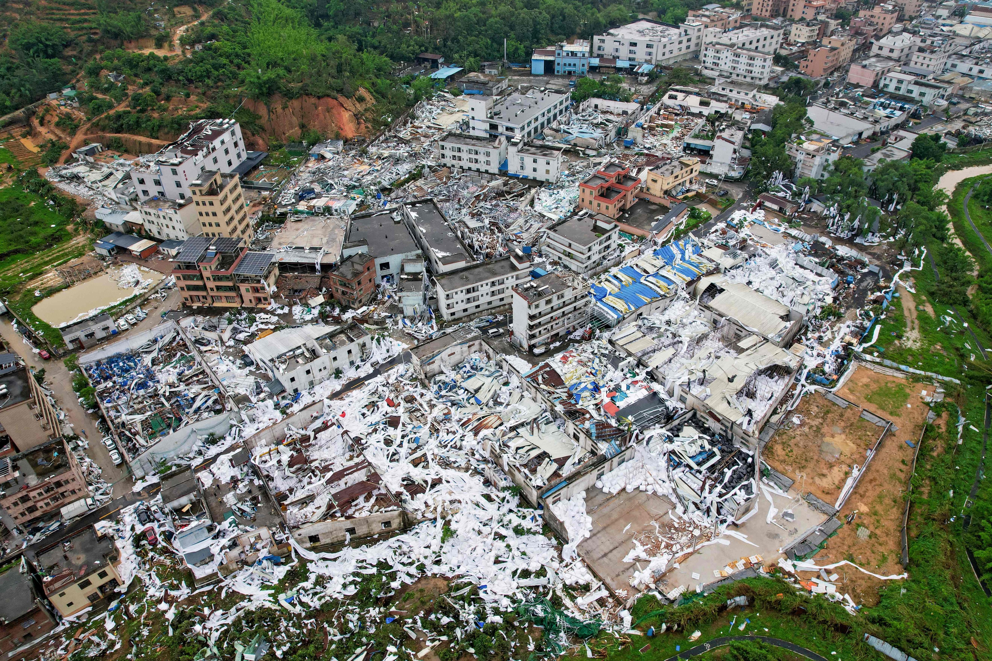 Widespread debris and damaged buildings seen in Baiyun district of Guangzhou in the aftermath of Saturday’s killer tornado. Photo: CNS/AFP