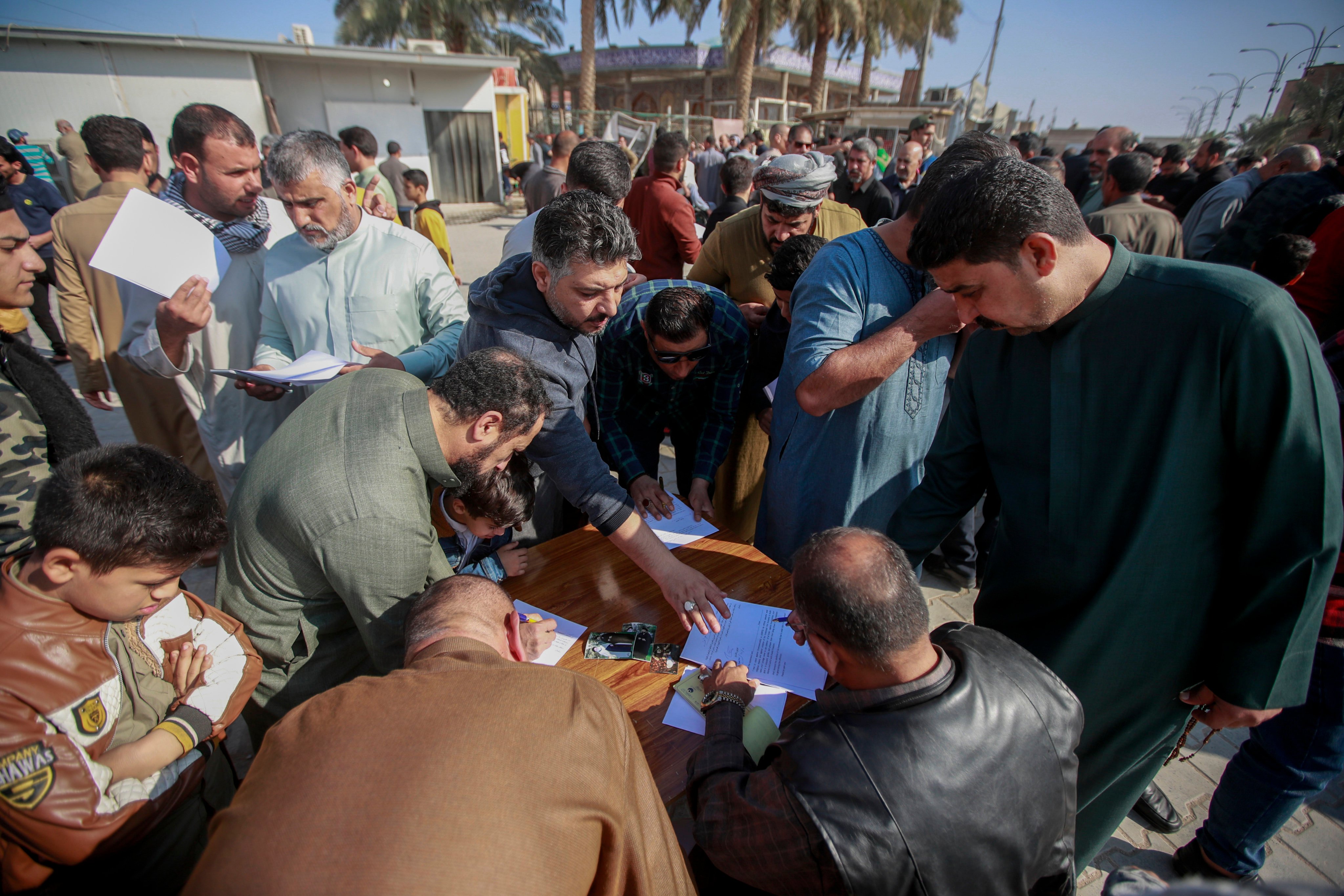 Iraqis sign a pledge to stand against homosexuality and LGBTQ people, outside a mosque in Kufa, Iraq. The country’s parliament on Saturday quietly passed a law that would impose heavy prison sentences on gay and transgender people. Photo: AP 
