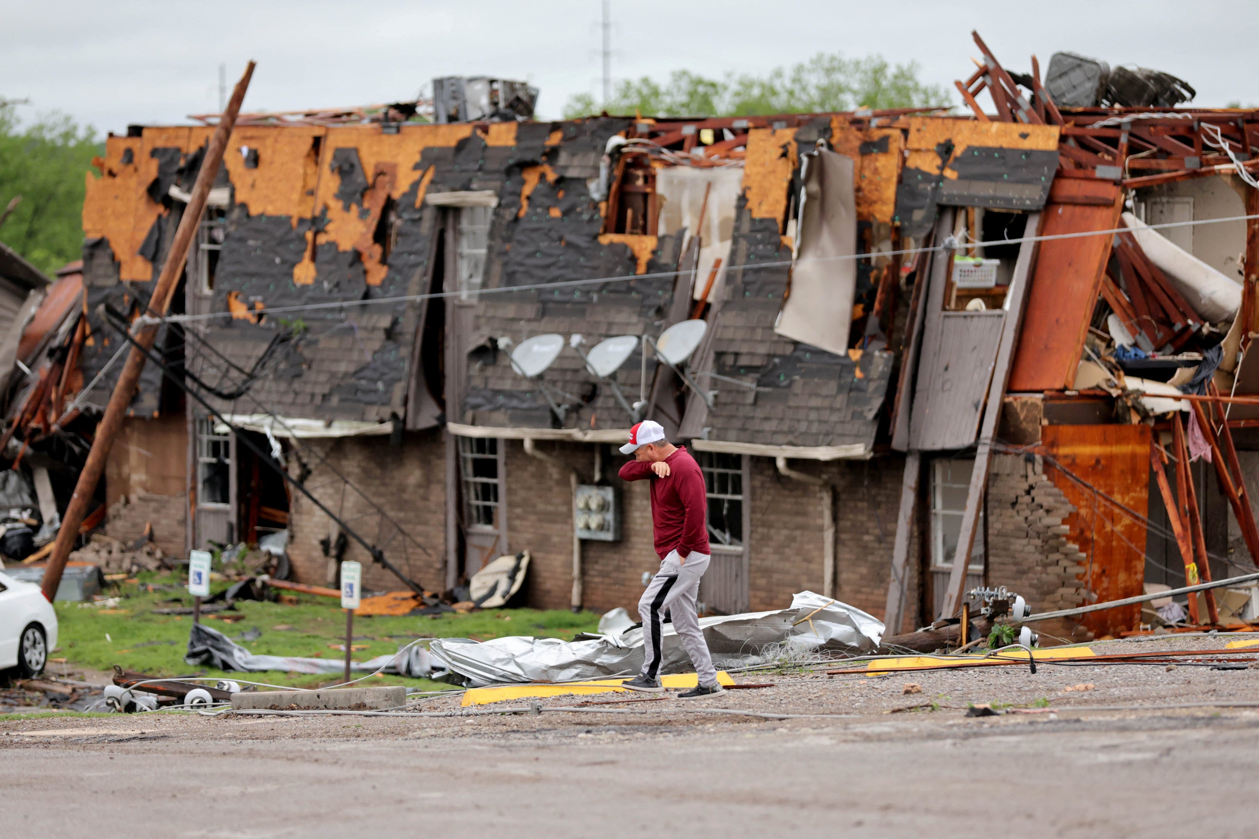 A man walks past a damaged building after it was hit by a tornado the night before in Sulphur, Oklahoma, US on Sunday. Photo: Bryan Terry / The Oklahoman / USA Today Network via Reuters