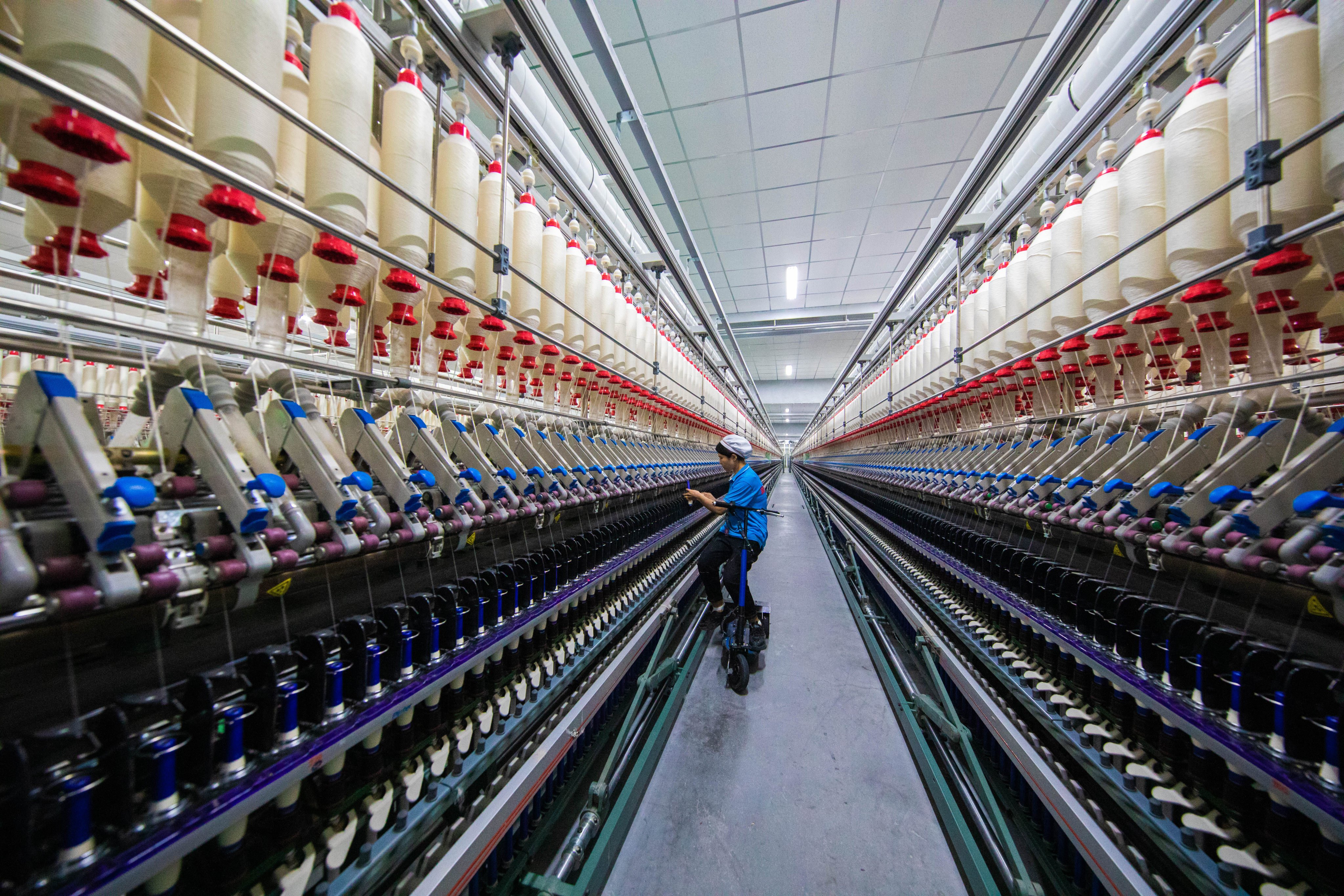 Spinning machines in Xinjiang textile factories are connected via 5G technology and being overseen by artificial intelligence, according to a team of scientists in China. Photo: Getty Images
