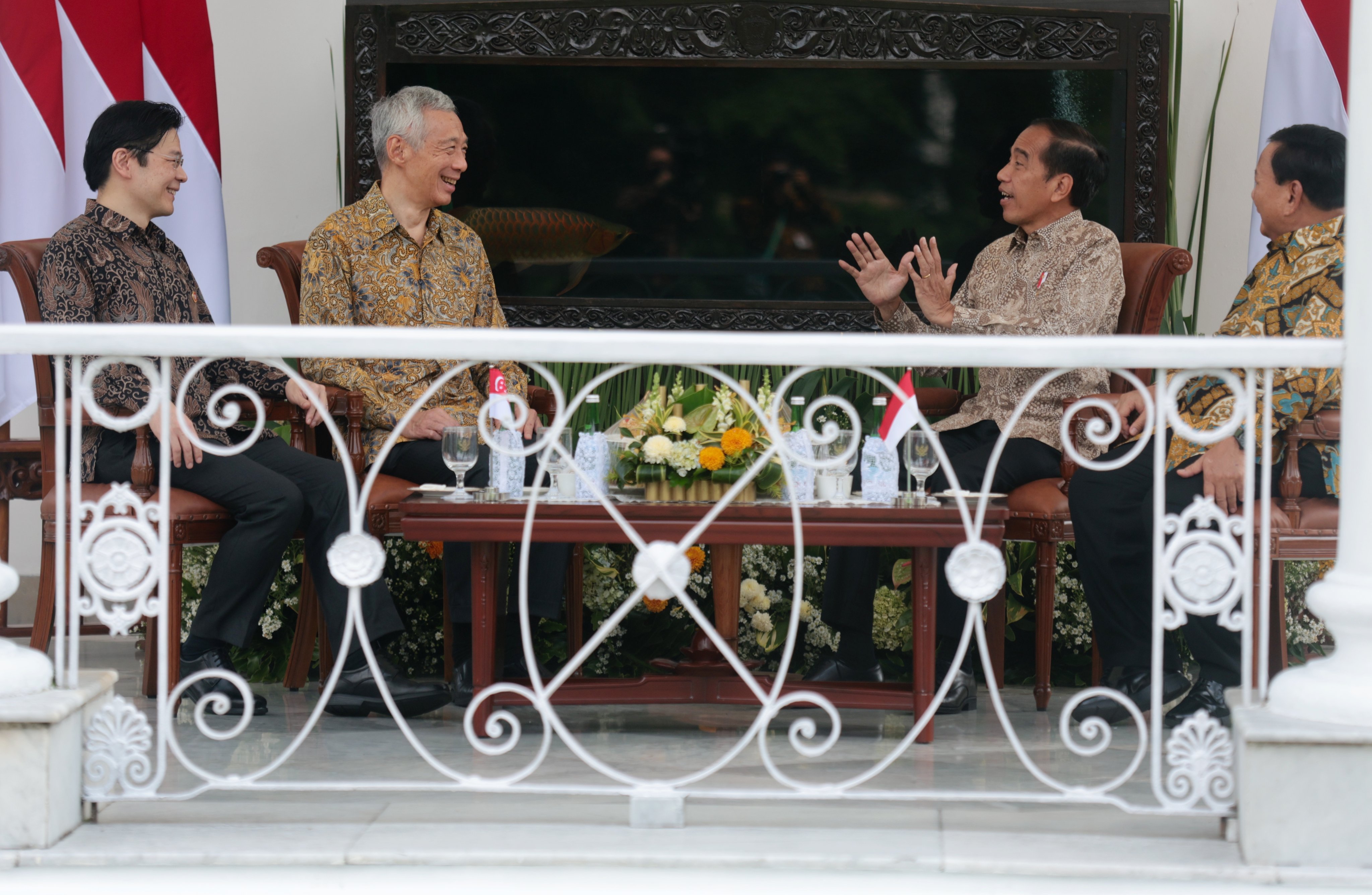 Singapore Prime Minister Lee Hsien Loong and his deputy Lawrence Wong talk to Indonesian President Joko Widodo and Defence Minister Prabowo Subianto during their meeting at the Presidential Palace in Bogor, Indonesia, on Monday. Photo: EPA-EFE