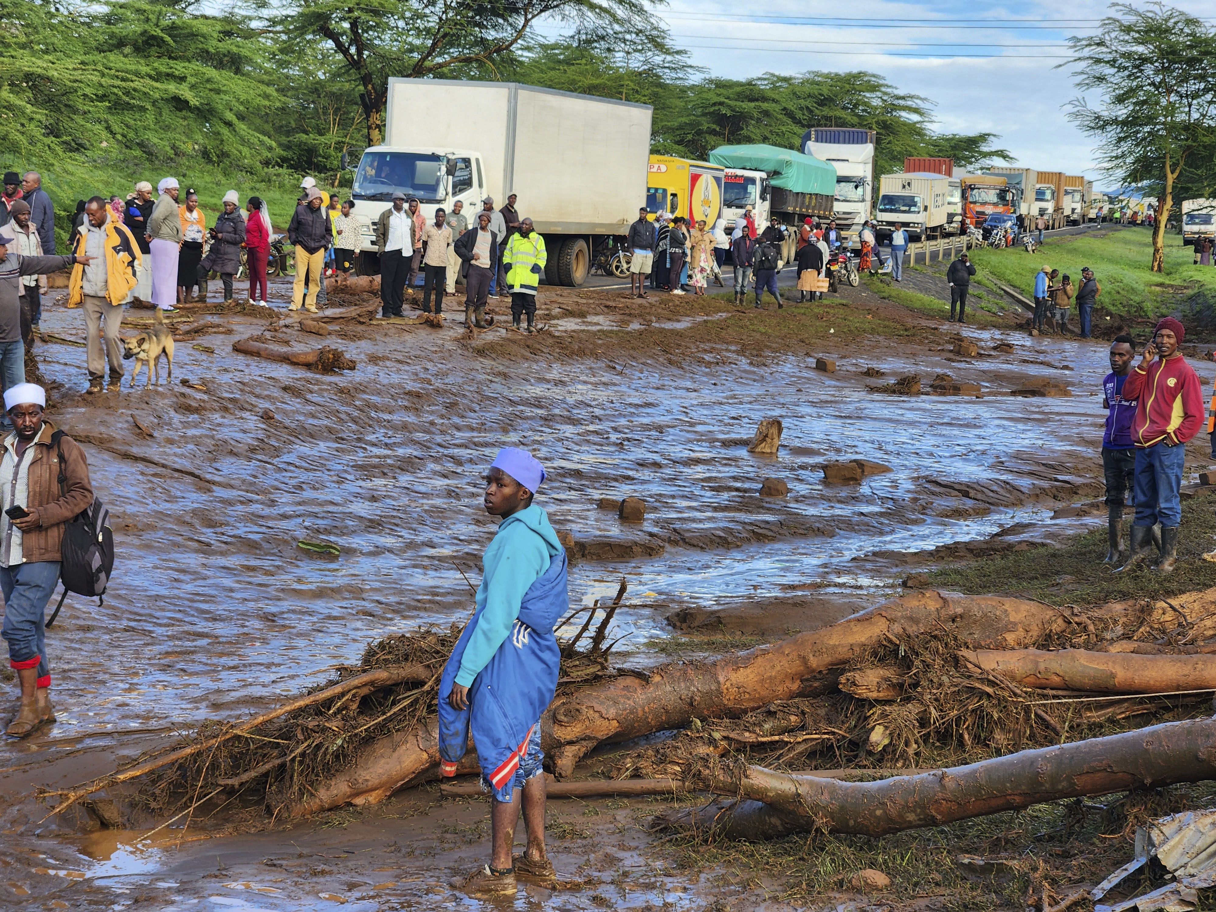 People gather on the main road after a dam burst, in Kamuchiri Village Mai Mahiu, Nakuru County, Kenya on Monday. Photo: AP