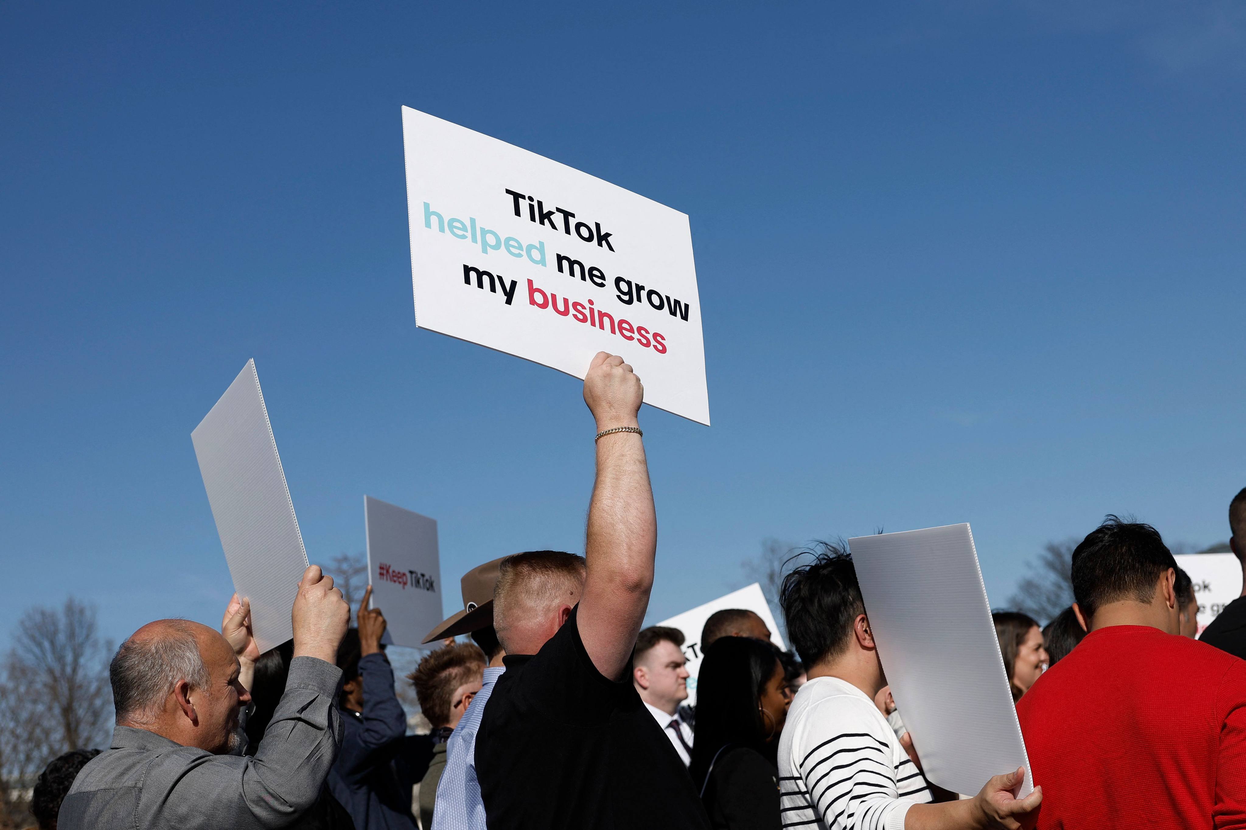 People hold up signs in support of TikTok at a news conference outside the US Capitol building in Washington on March 12. Photo: Getty Images/AFP