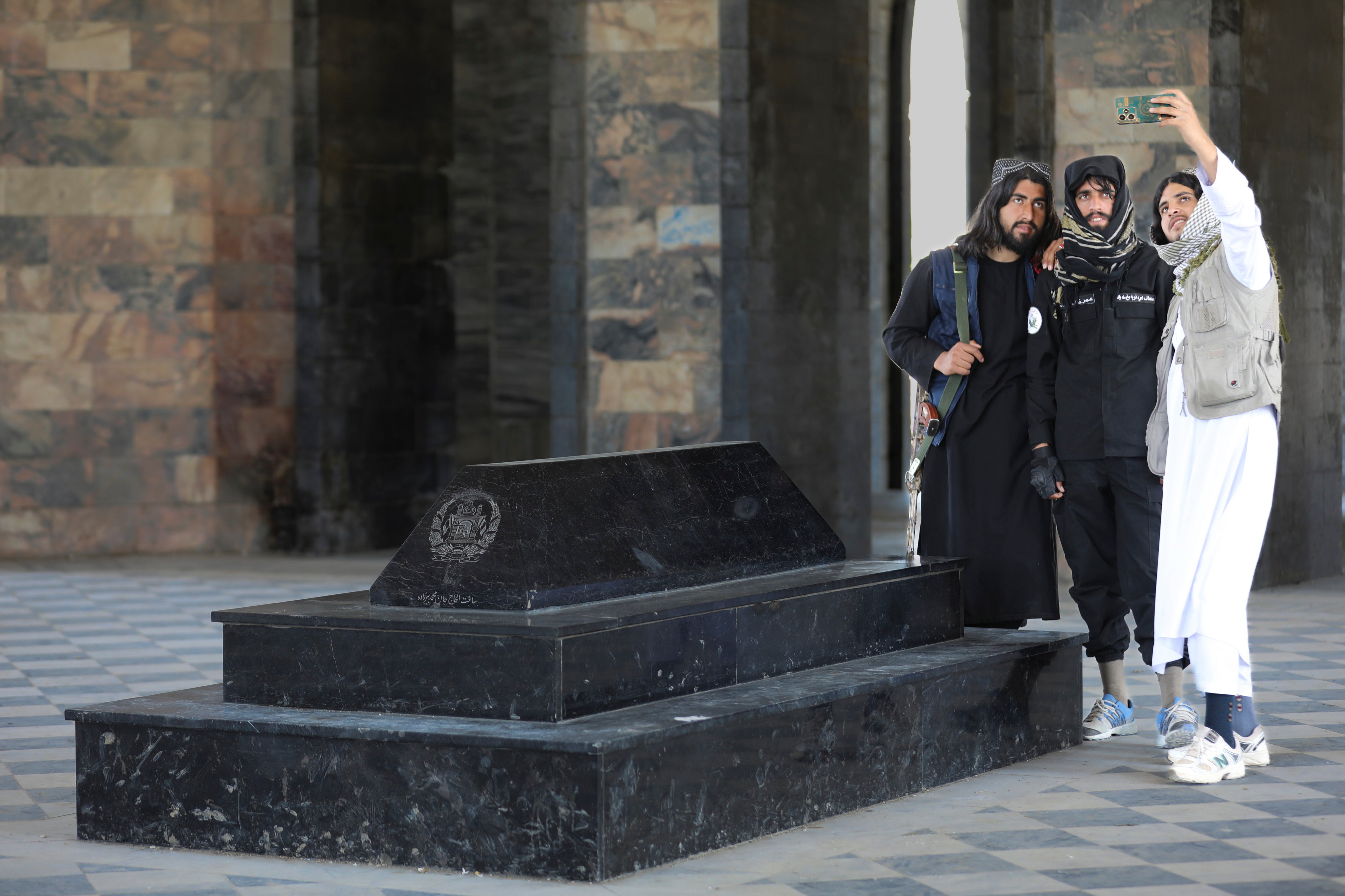 Taliban fighters take selfies by the tomb of Afghan King Nadir Shah in Kabul, Afghanistan. Photo: AP