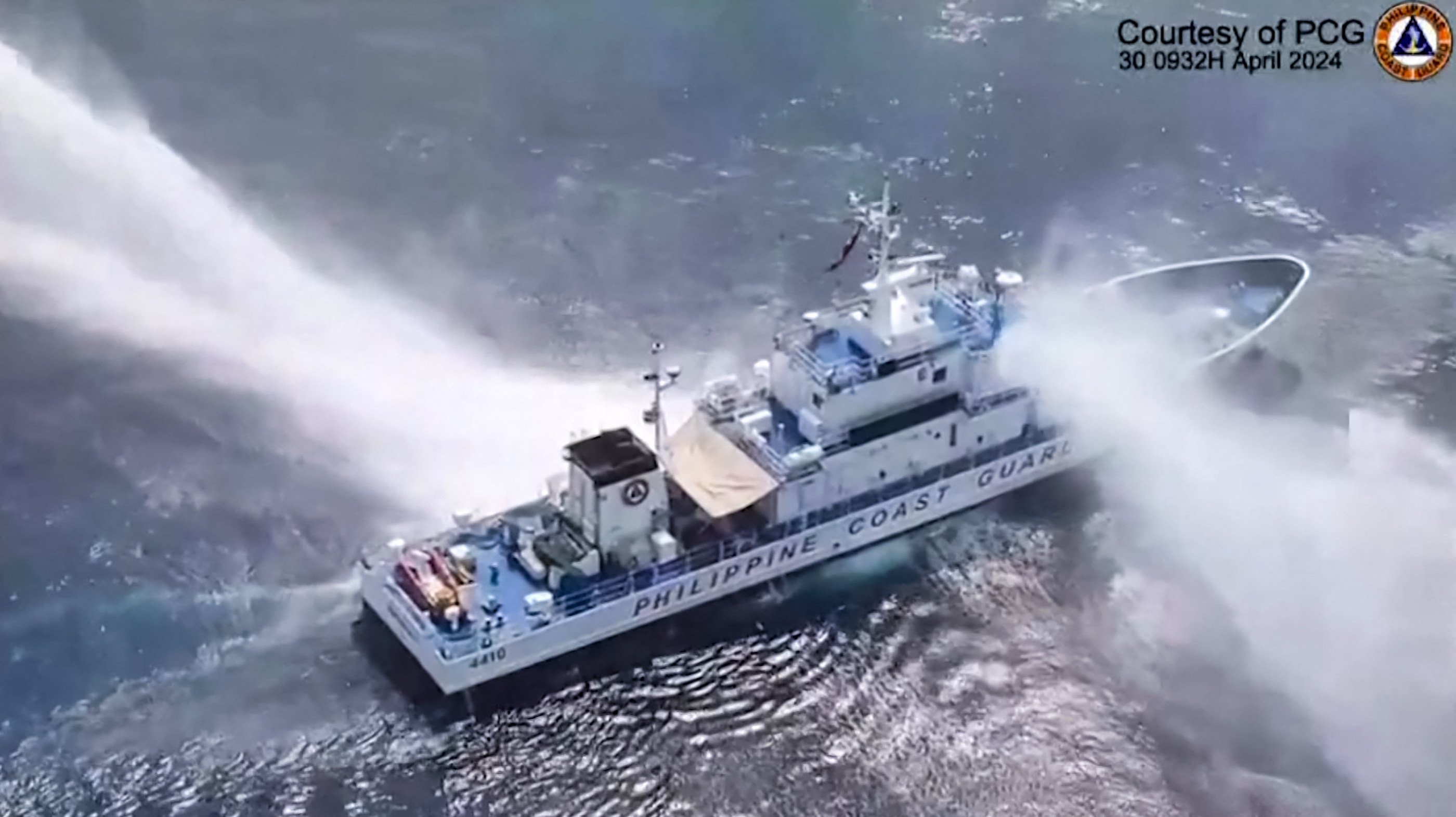 Philippine Coast Guard ship BRP Bagacay is hit by water cannons from Chinese vessels near Scarborough Shoal in the South China Sea on Tuesday. Photo: AFP / Philippine Coast Guard