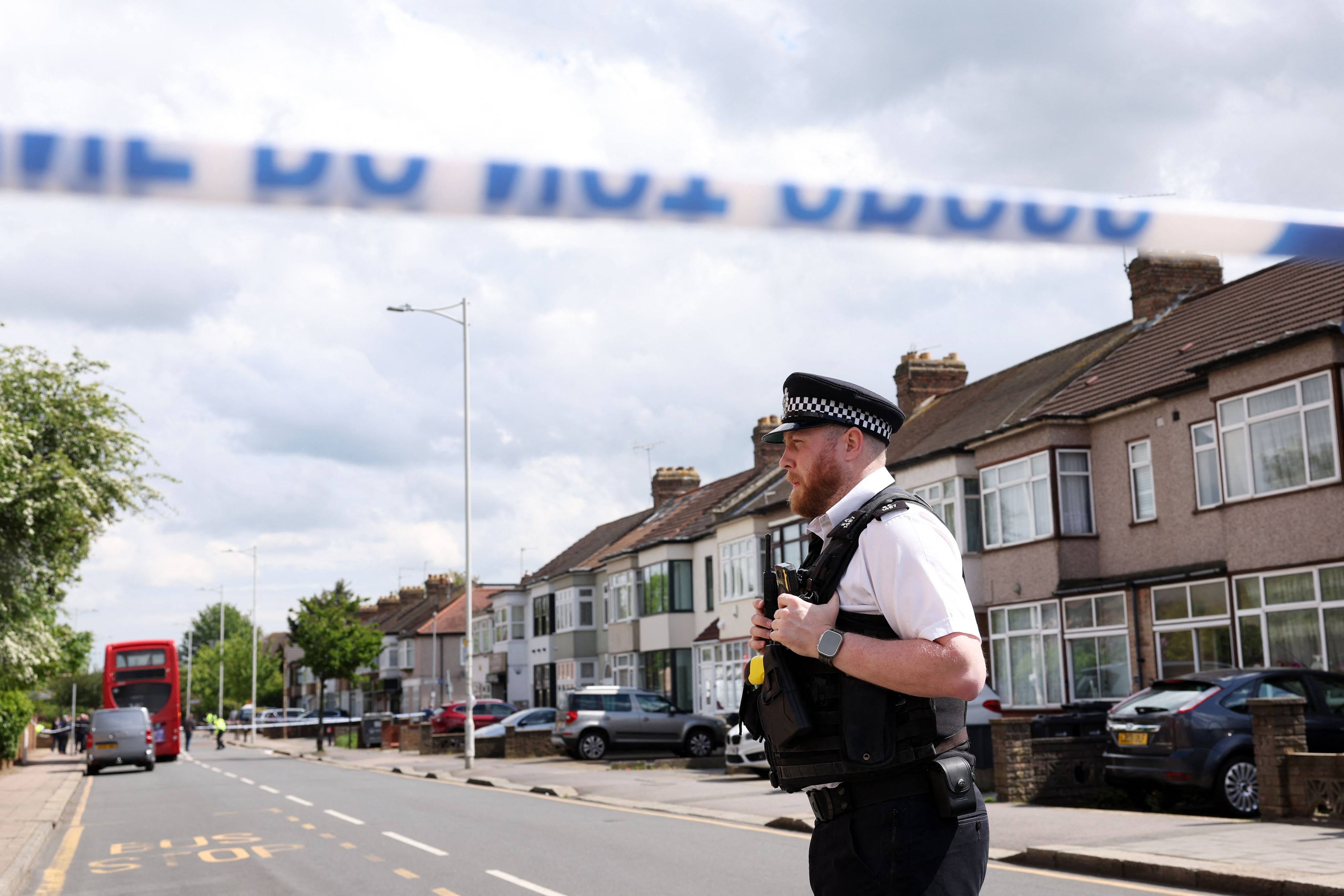 Police officers attend a crime scene in Hainault, east of London on Monday, where a 36-year-old man wielding a sword was arrested following an attack on members of the public and two police officers. Photo: AFP
