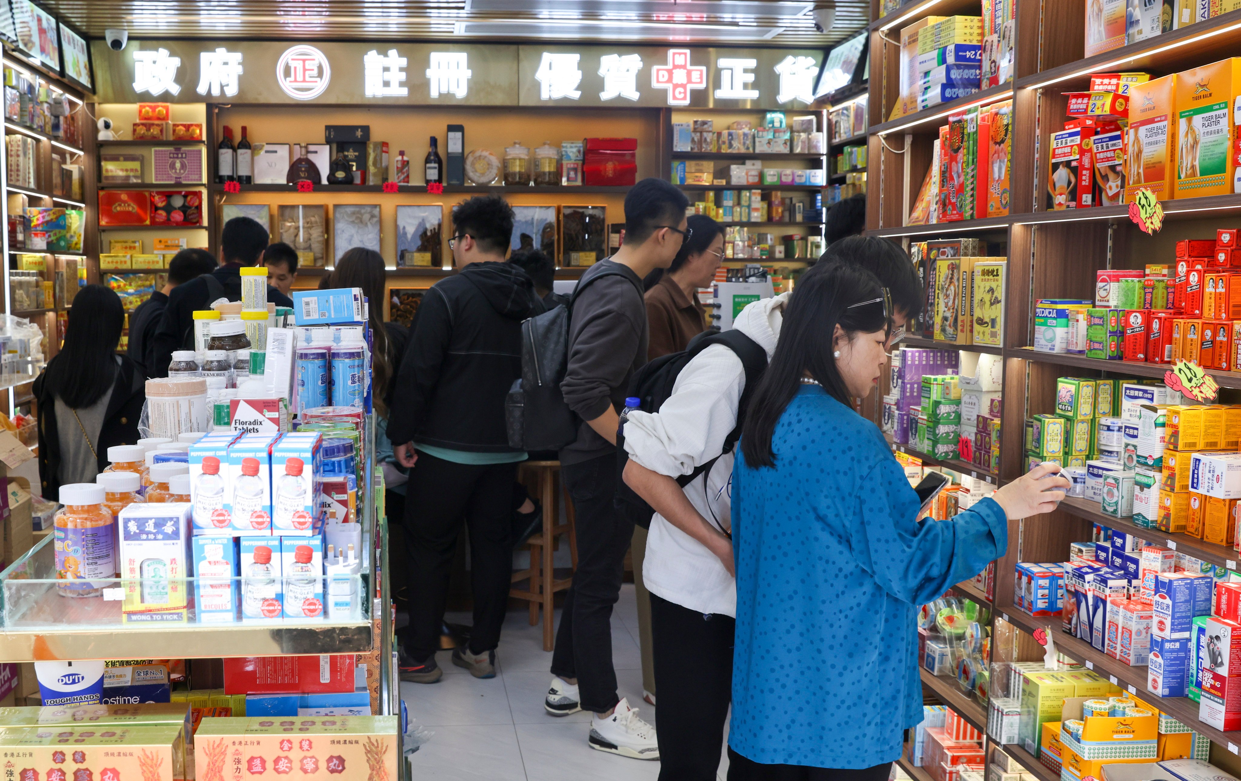 Tourists visit a pharmacy in Tsim Sha Tsui. The golden week holiday is expected to attract an influx of tourists from mainland China. Photo: Yik Yeung-man