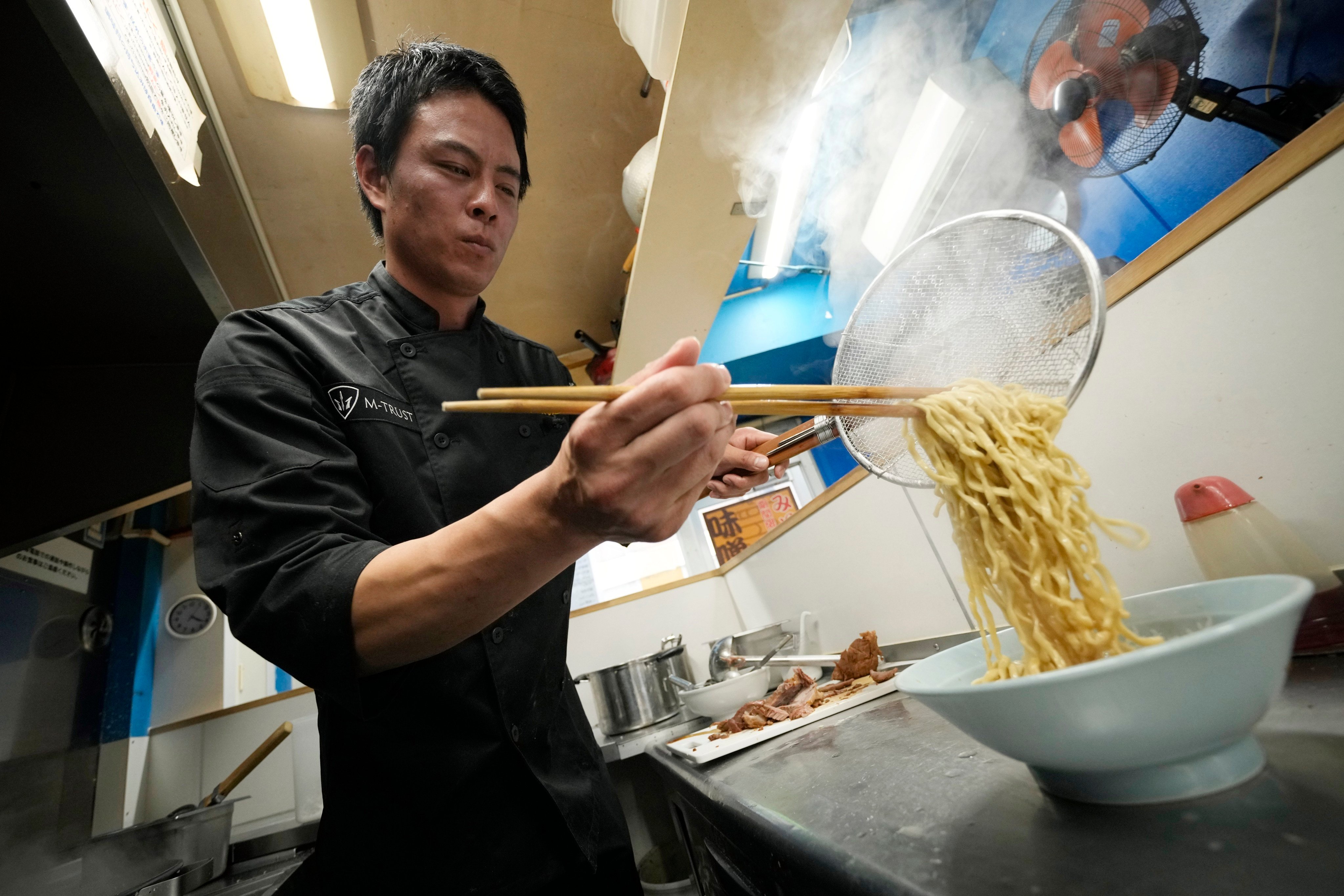 Kota Kobayashi prepares a bowl of ramen noodles. He runs a restaurant chain called Ore No Ikiru Michi in Tokyo. Photo: AP 