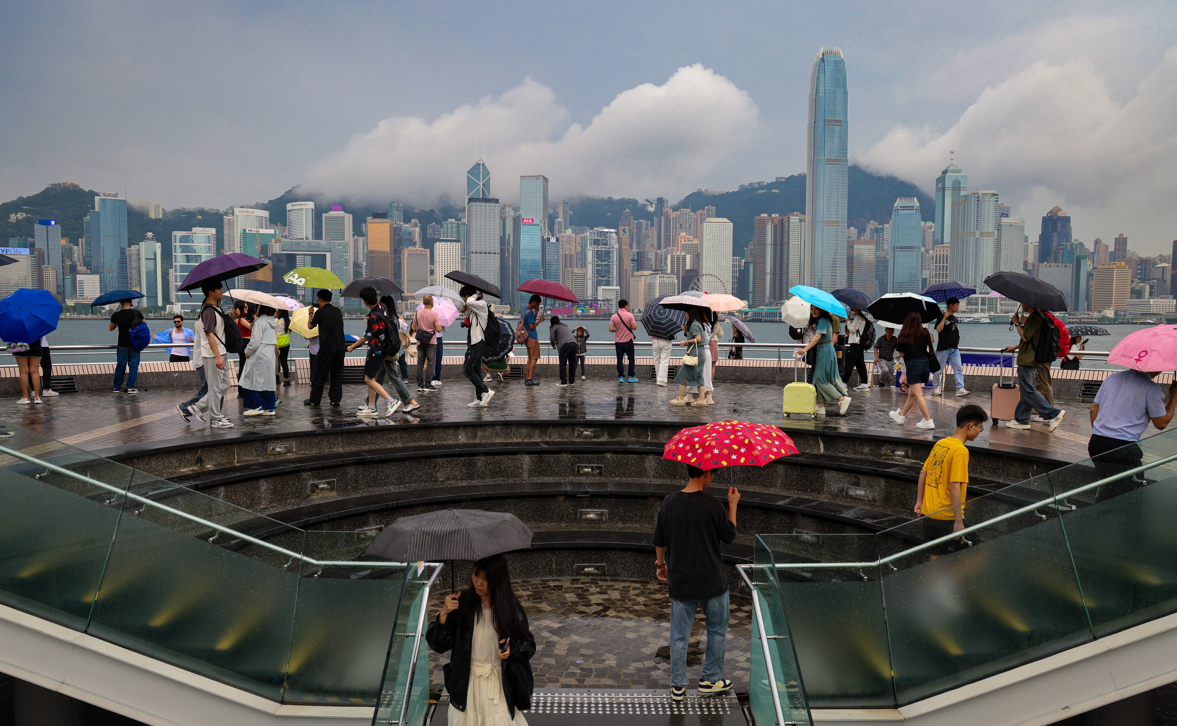 Tourists visit the Tsim Sha Tsui waterfront despite the weather. Photo: Jelly Tse