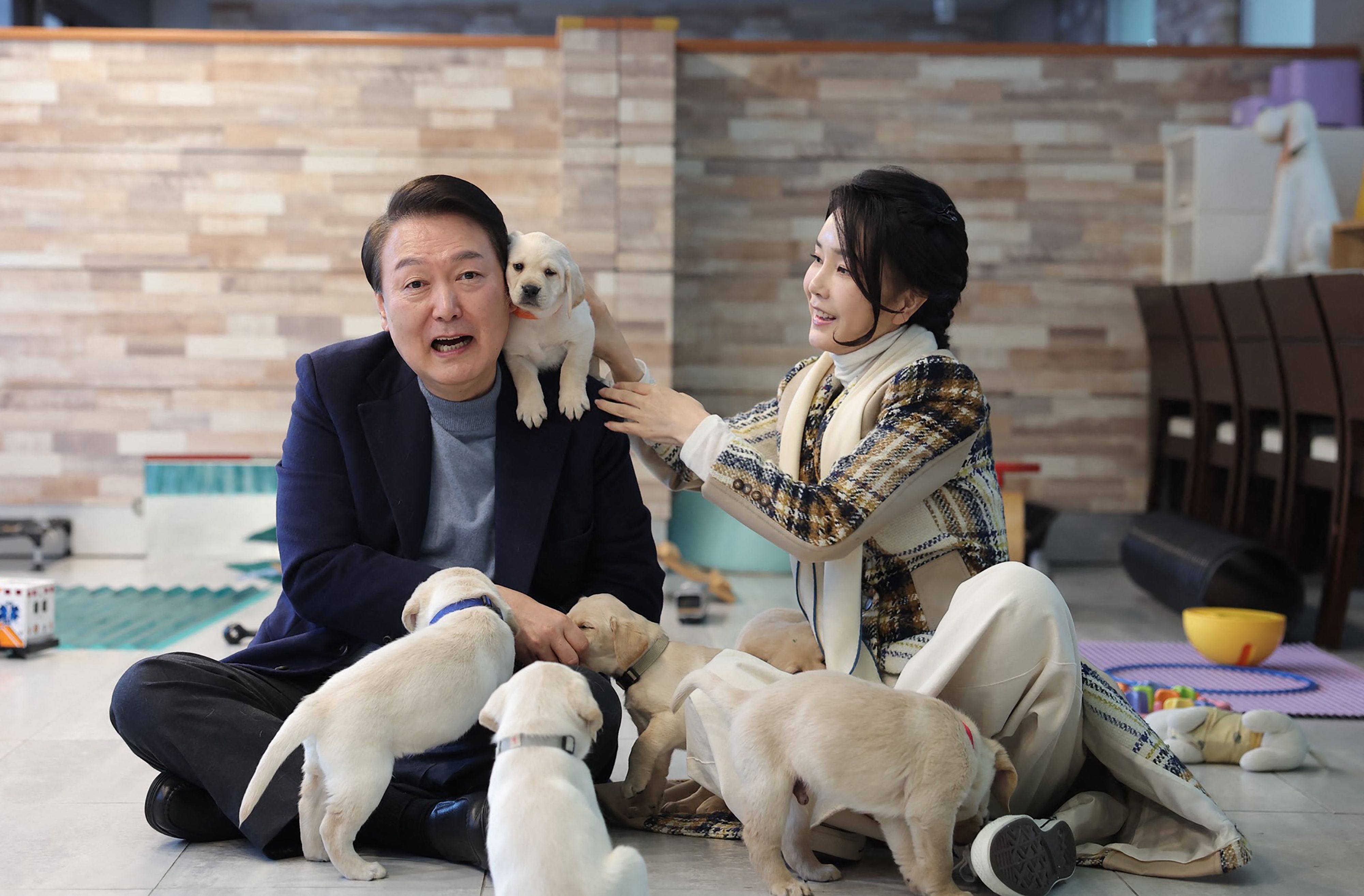 South Korean President Yoon Suk-yeol and first lady Kim Keon- hee posing with puppies at a school in Yongin. Photo: AFP