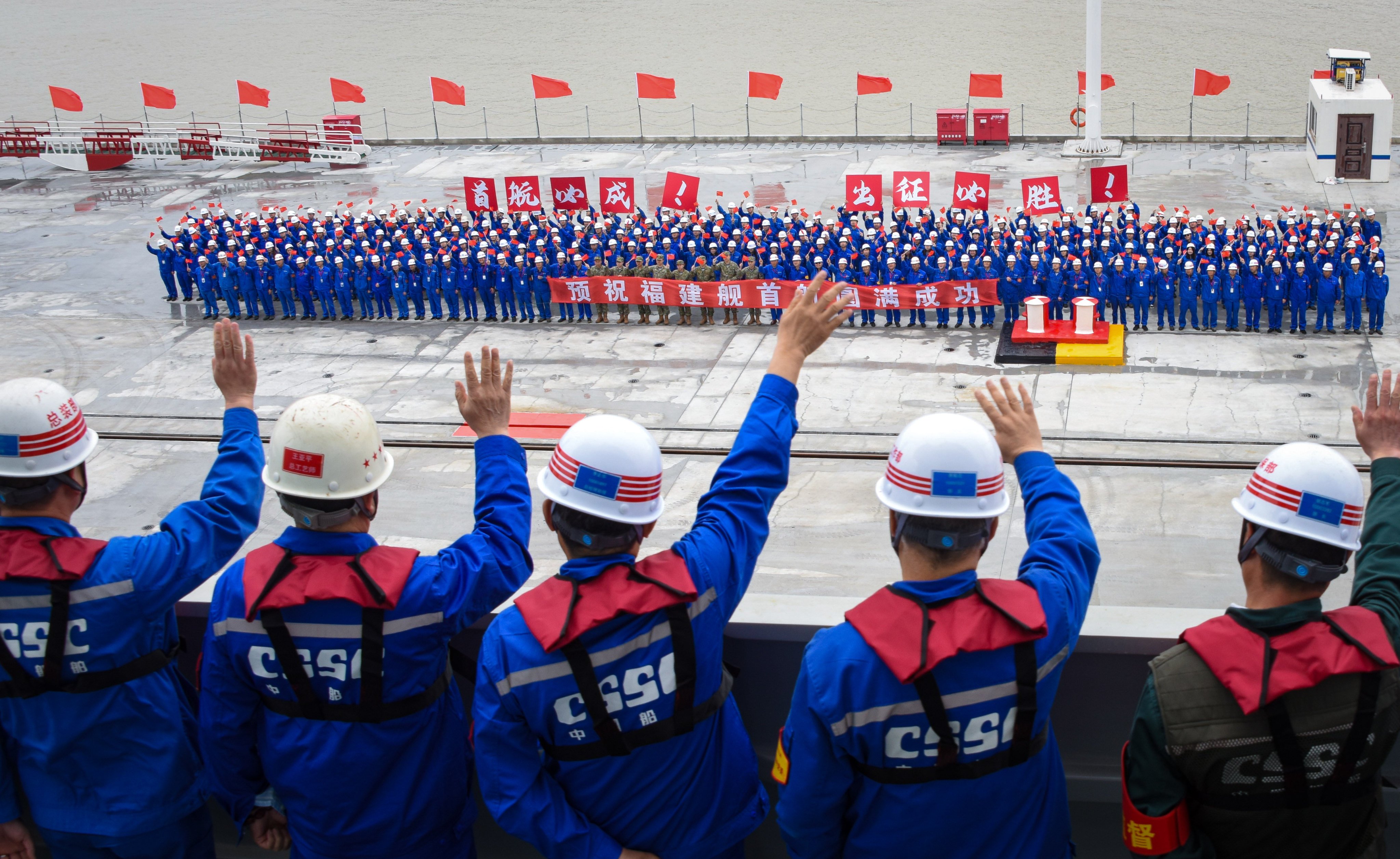 Well-wishers wave as China’s Fujian aircraft carrier leaves its dock in Shanghai on its maiden voyage to begin sea trials which are expected to take about a year. Photo: Xinhua