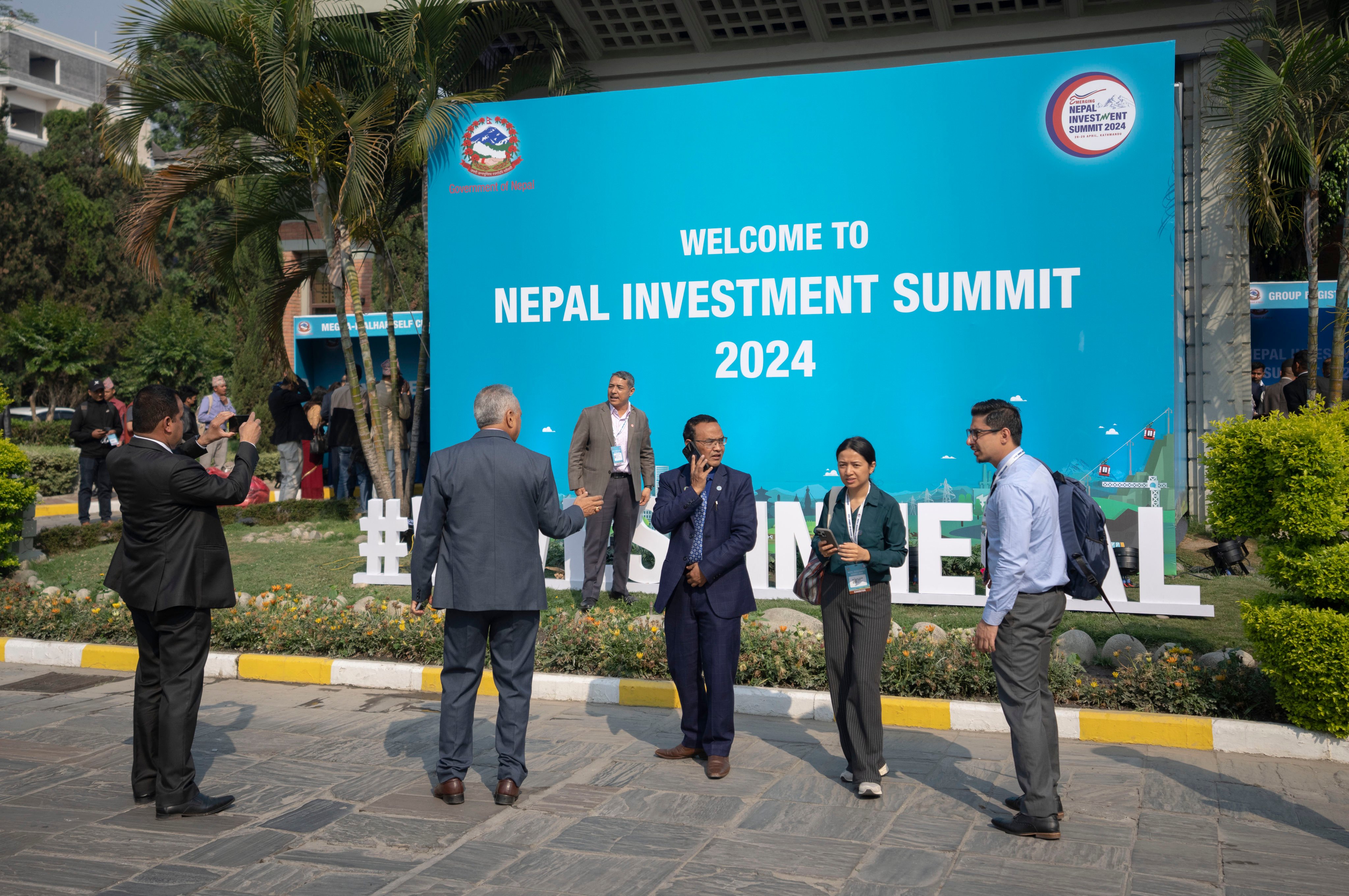Participants of Nepal Investment Summit take photos during the first day of the event in Kathmandu. Photo: AP
