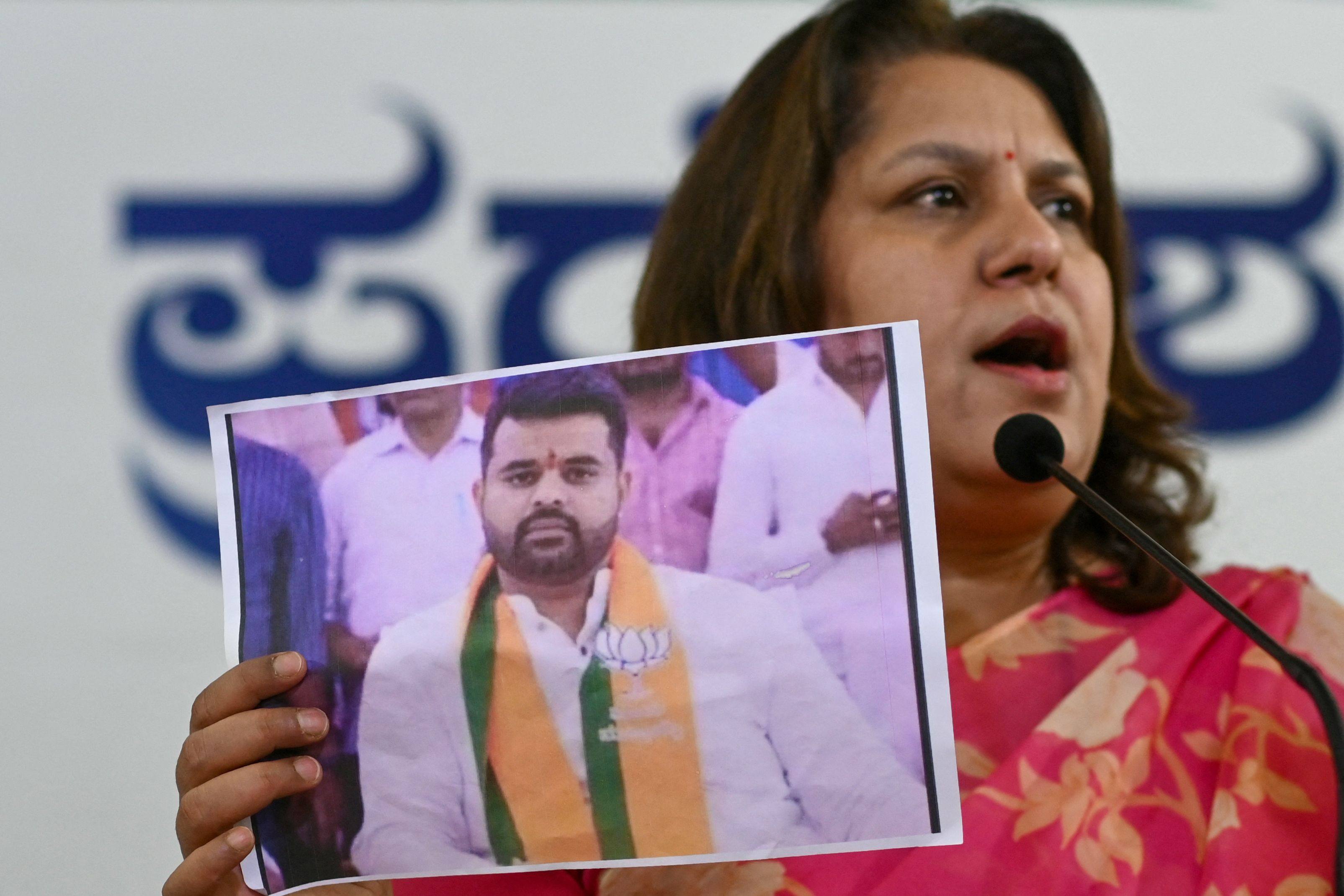 Congress spokeswoman Supriya Shrinate shows a photograph featuring JD(S) MP Prajwal Revanna who has been summoned for an alleged sexual abuse case. Photo: AFP