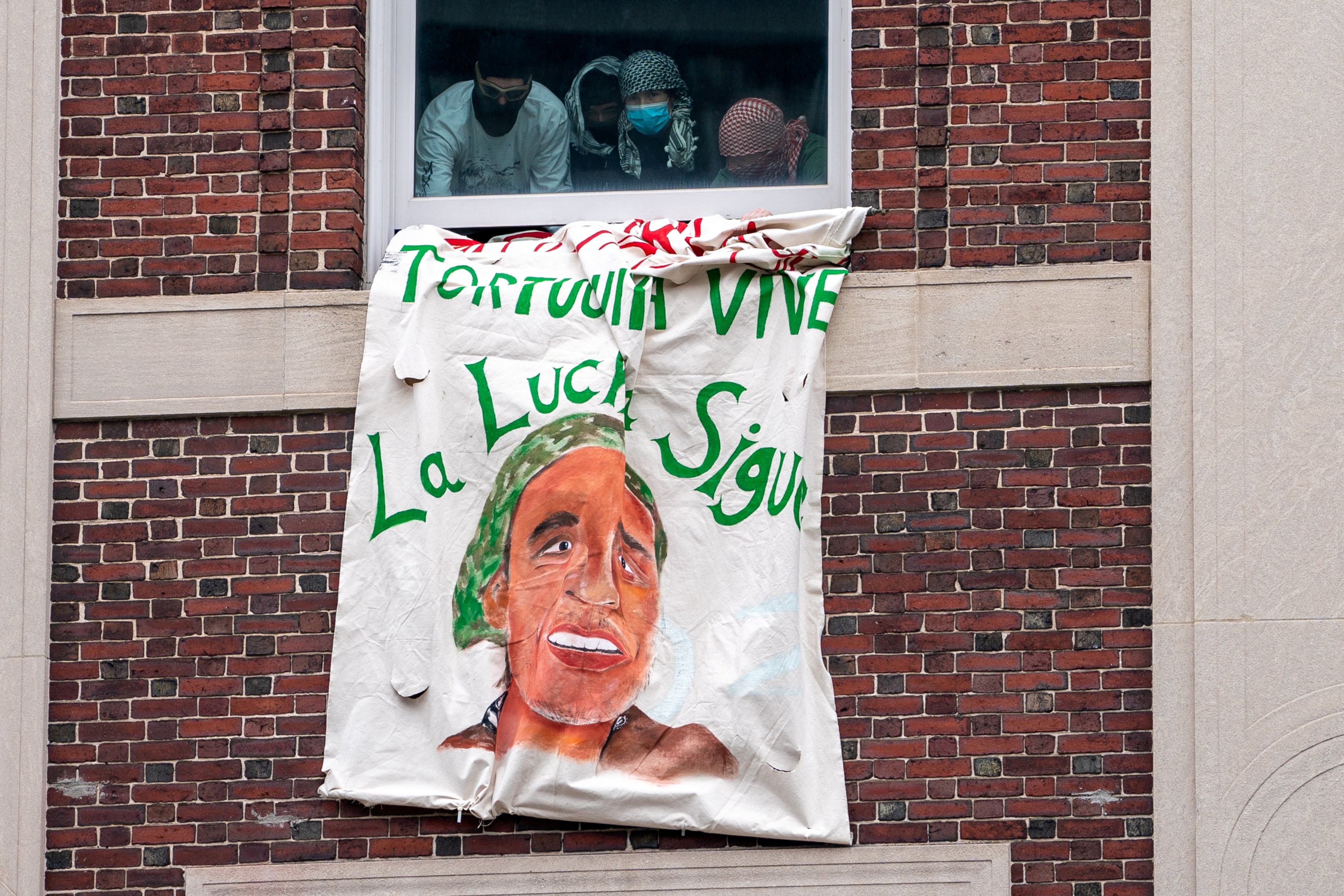 People occupying Hamilton Hall at Columbia University unfurl a banner at the main campus in New York on Tuesday. Photo: Reuters