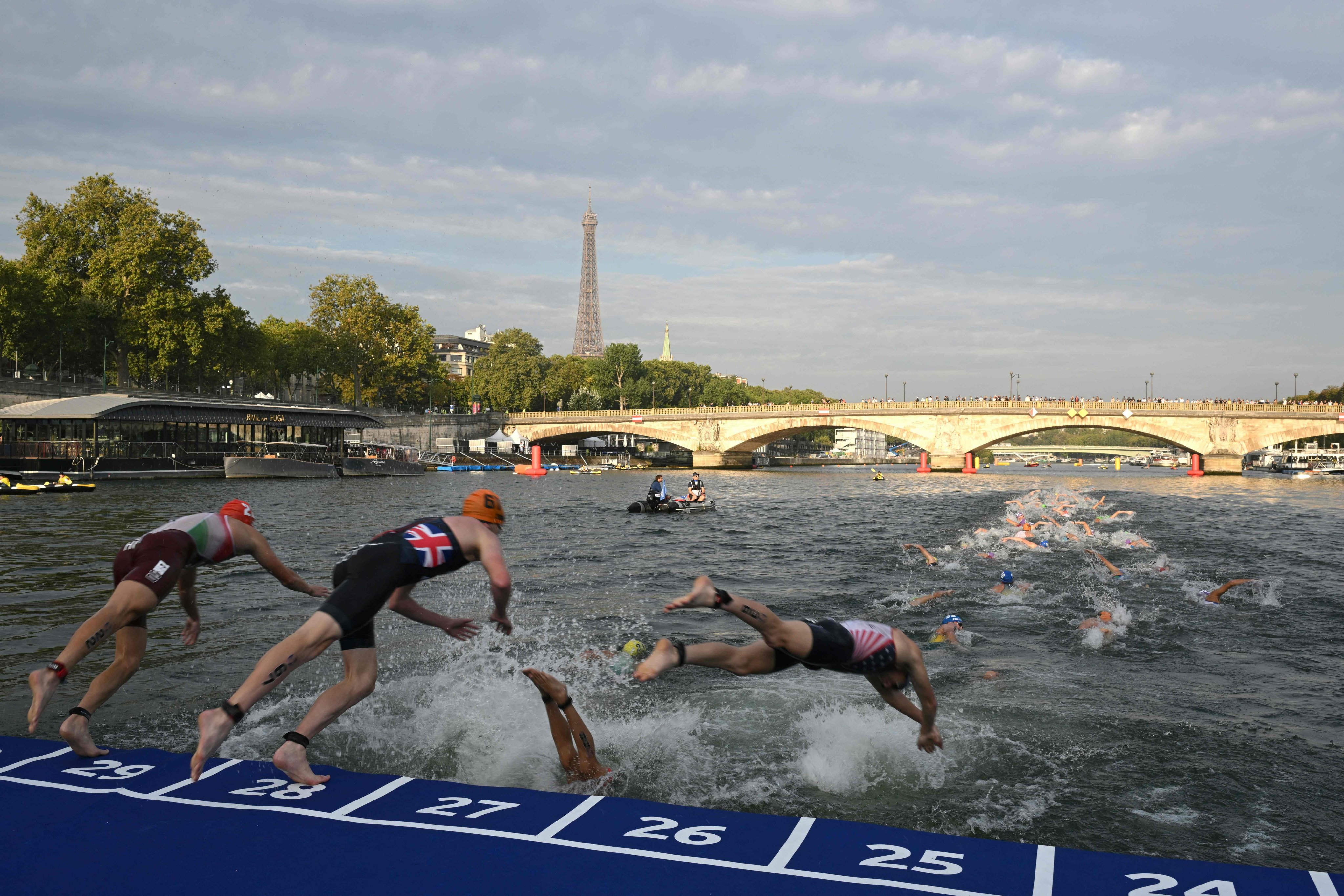 Triathlon athletes dive into the river Seine during an Olympic Games test event in Paris in 2023. A clean-up of the river is taking place to make it fit for the Olympic Games this summer, and public swimming in the river could be allowed after that. Photo: AFP