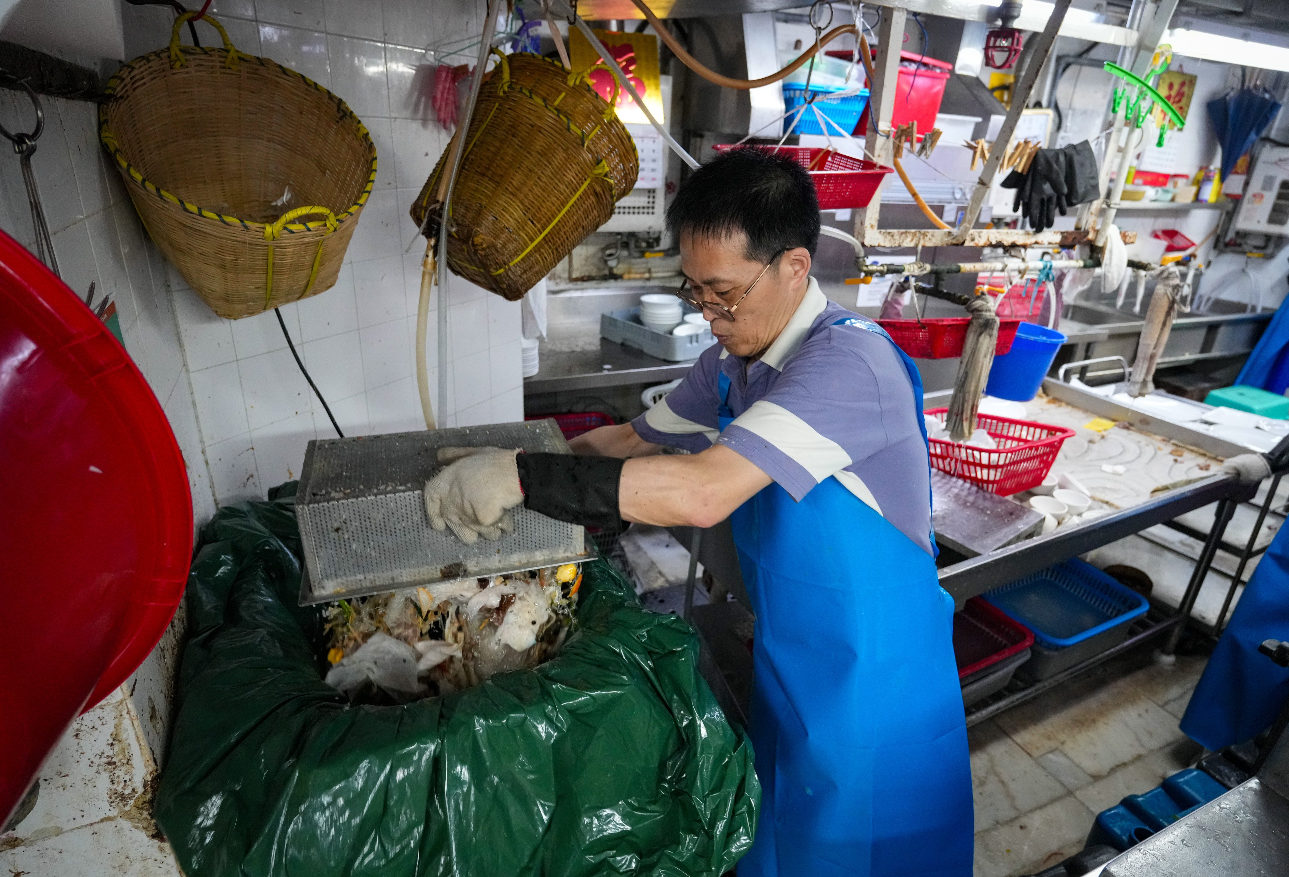 A worker at a restaurant taking part in a trial run of the waste-charging scheme. Authorities are expected to brief legislators on the results later this month. Photo: Sam Tsang