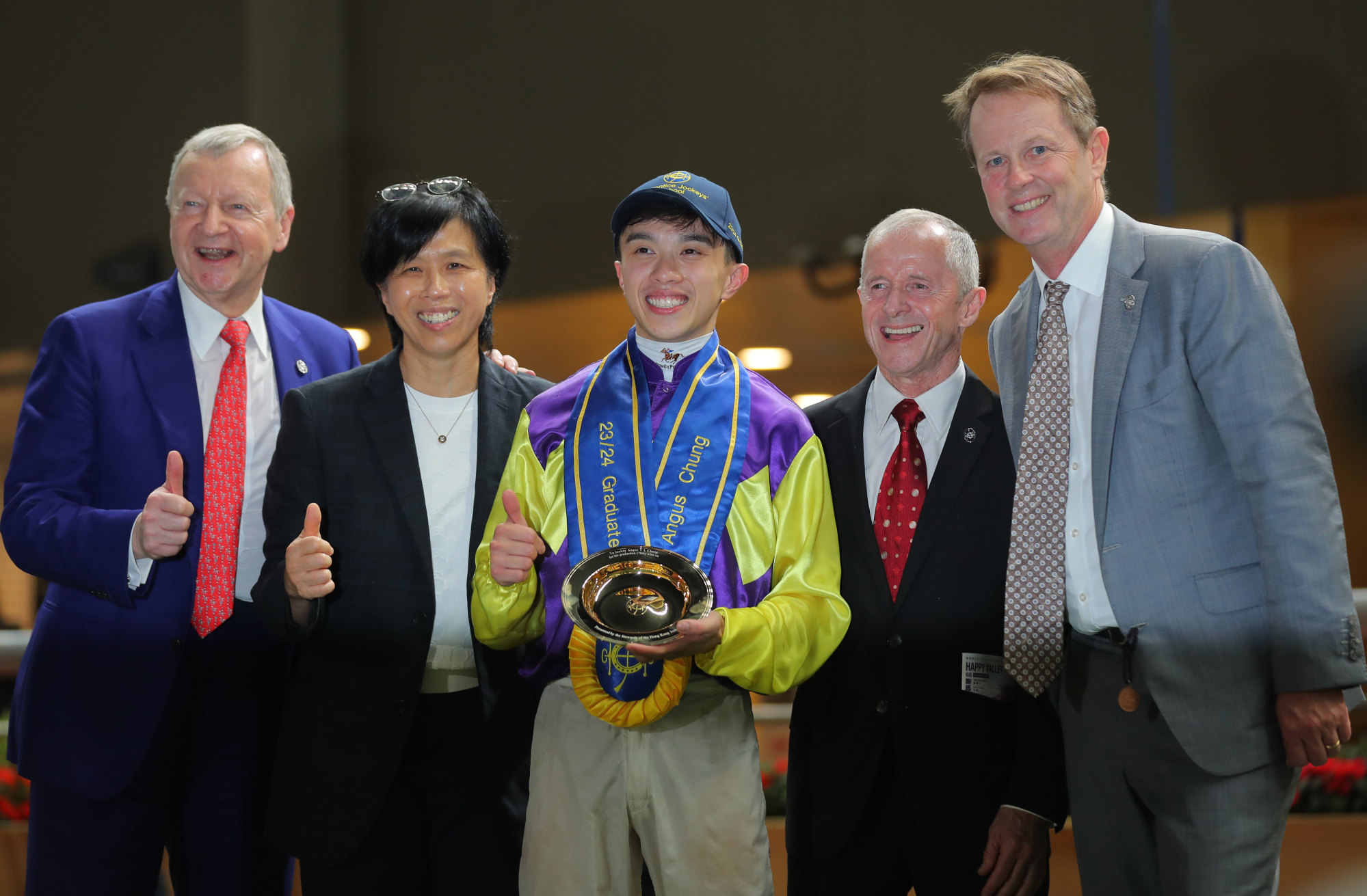 Angus Chung (centre) and Jockey Club officials at the apprentice’s graduation ceremony.