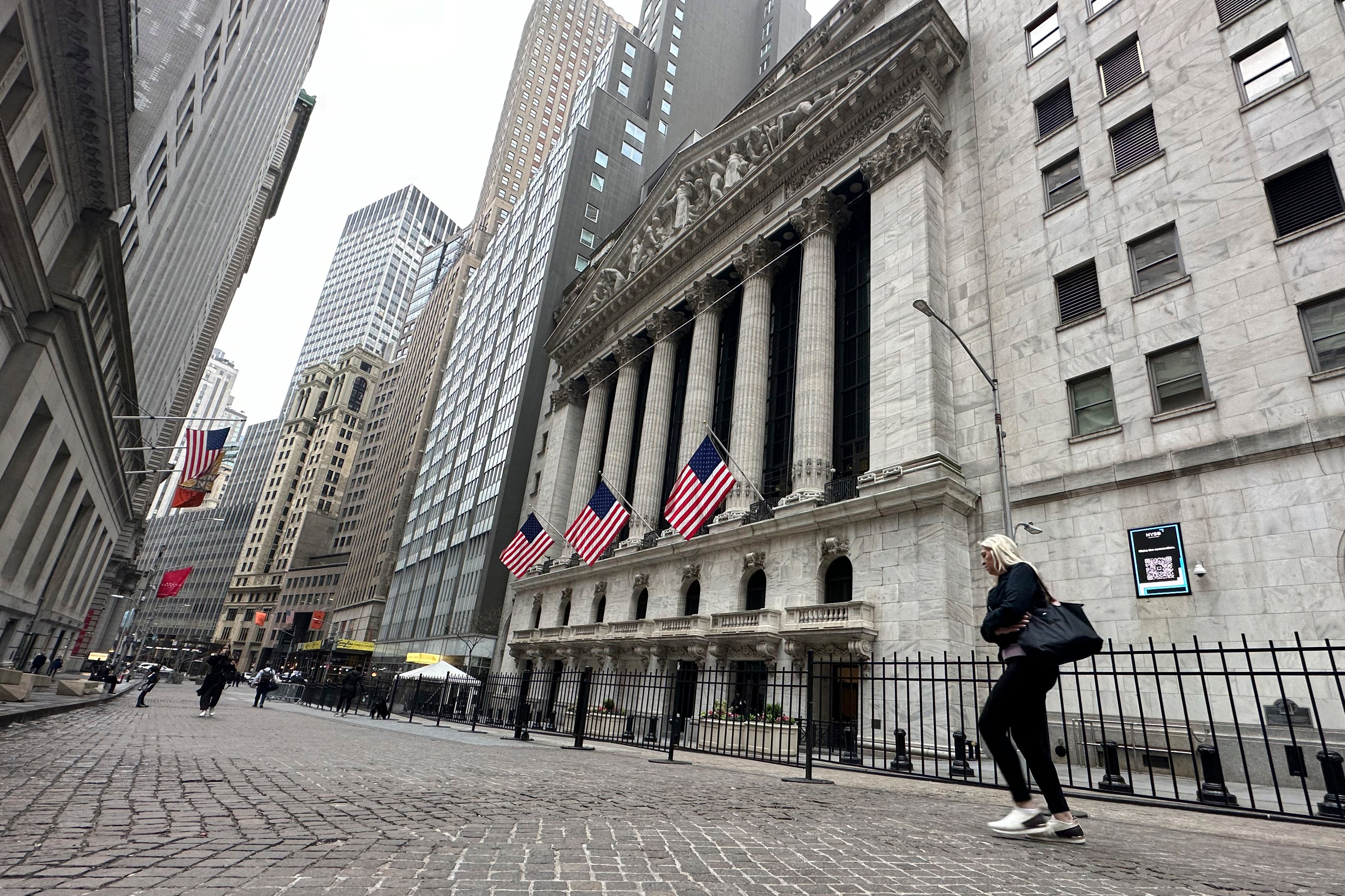A person walks past the New York Stock Exchange on April 30. After reaching all-time highs in March, US stock prices retreated in April and have generally been looking wobbly. Photo: AP