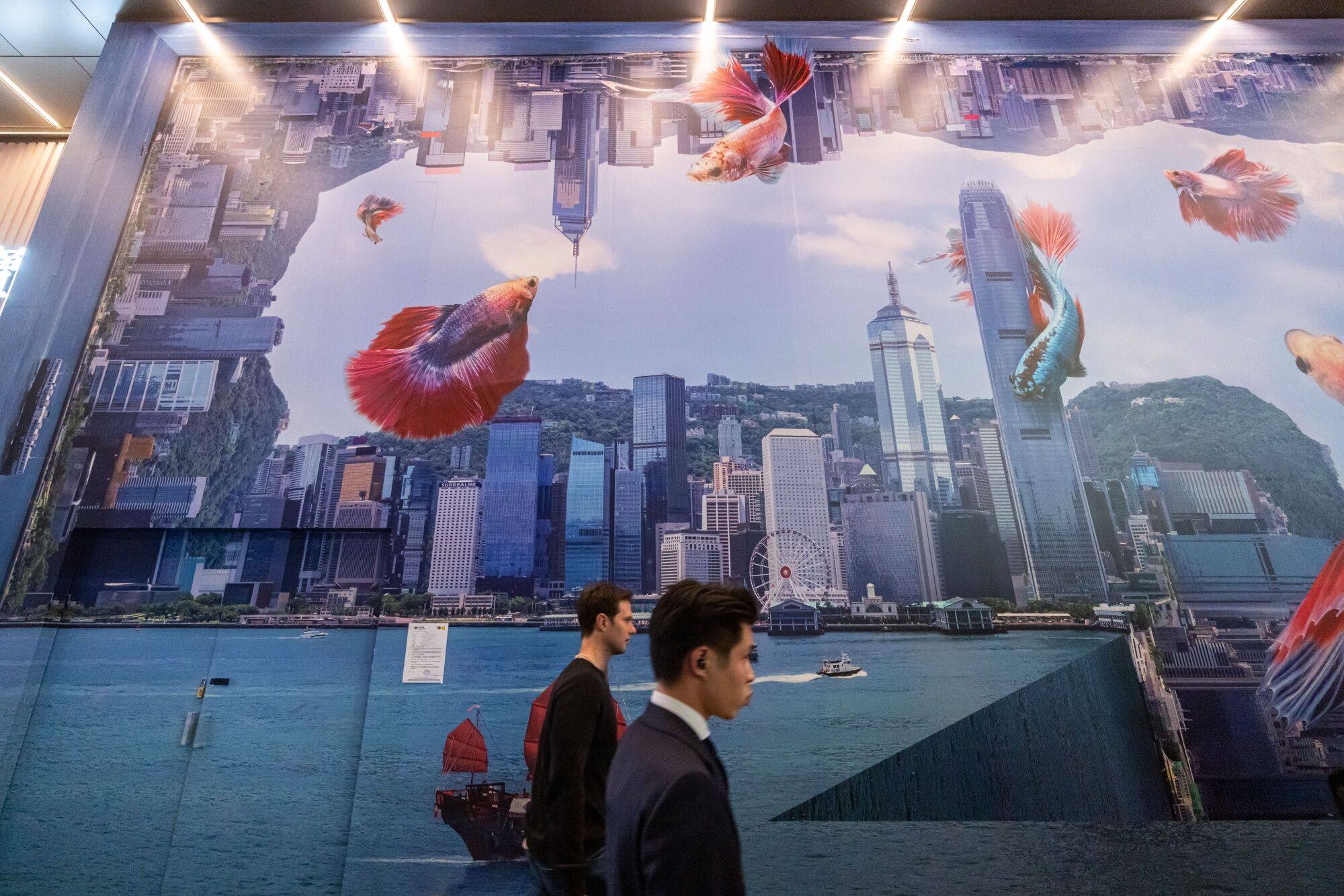 Pedestrians passed a backdrop of the city skyline on a street in the Central district in Hong Kong. Photo: Bloomberg