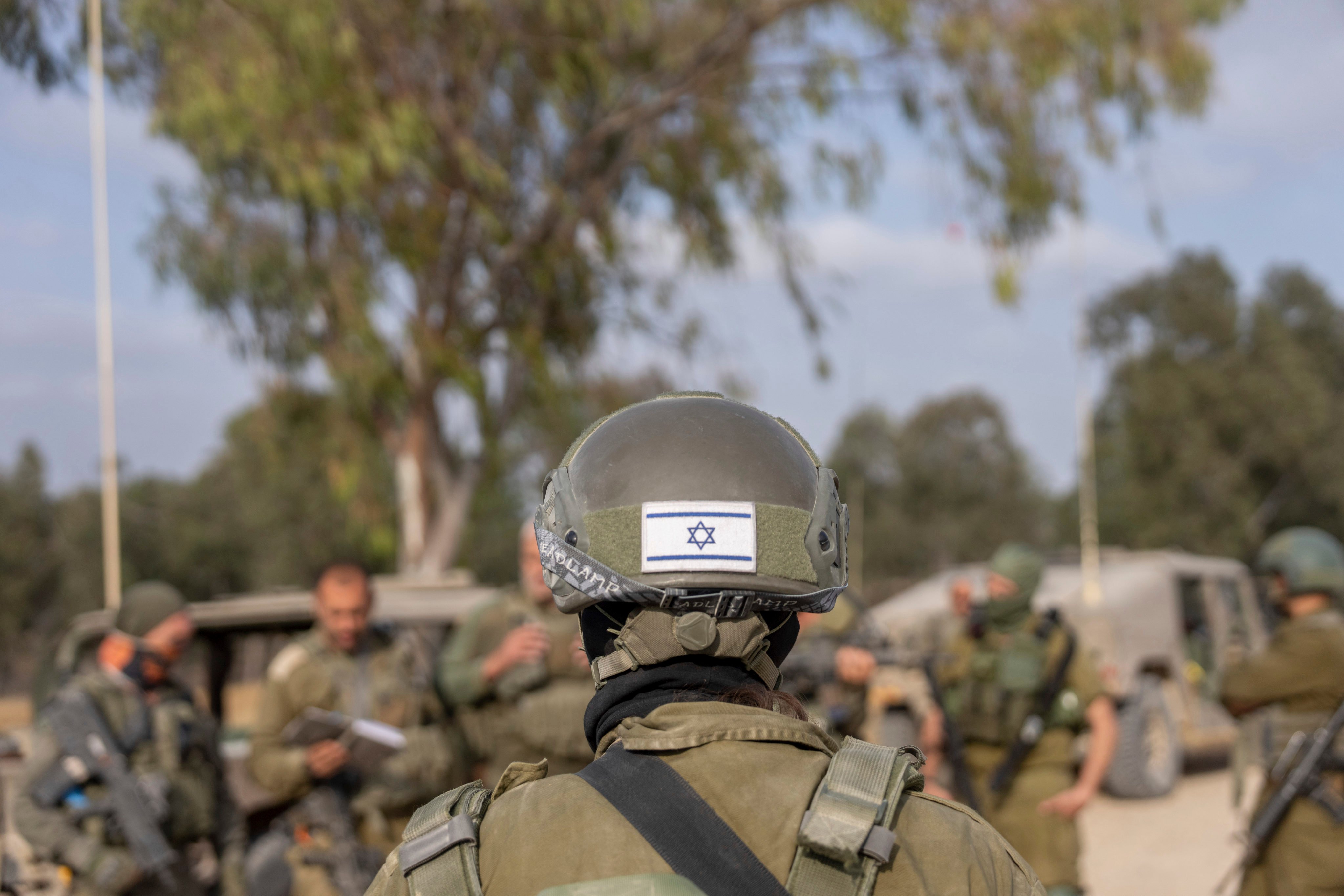 Israeli soldiers gather near the Israeli-Gaza border in southern Israel before they enter the Gaza Strip. Photo: AP