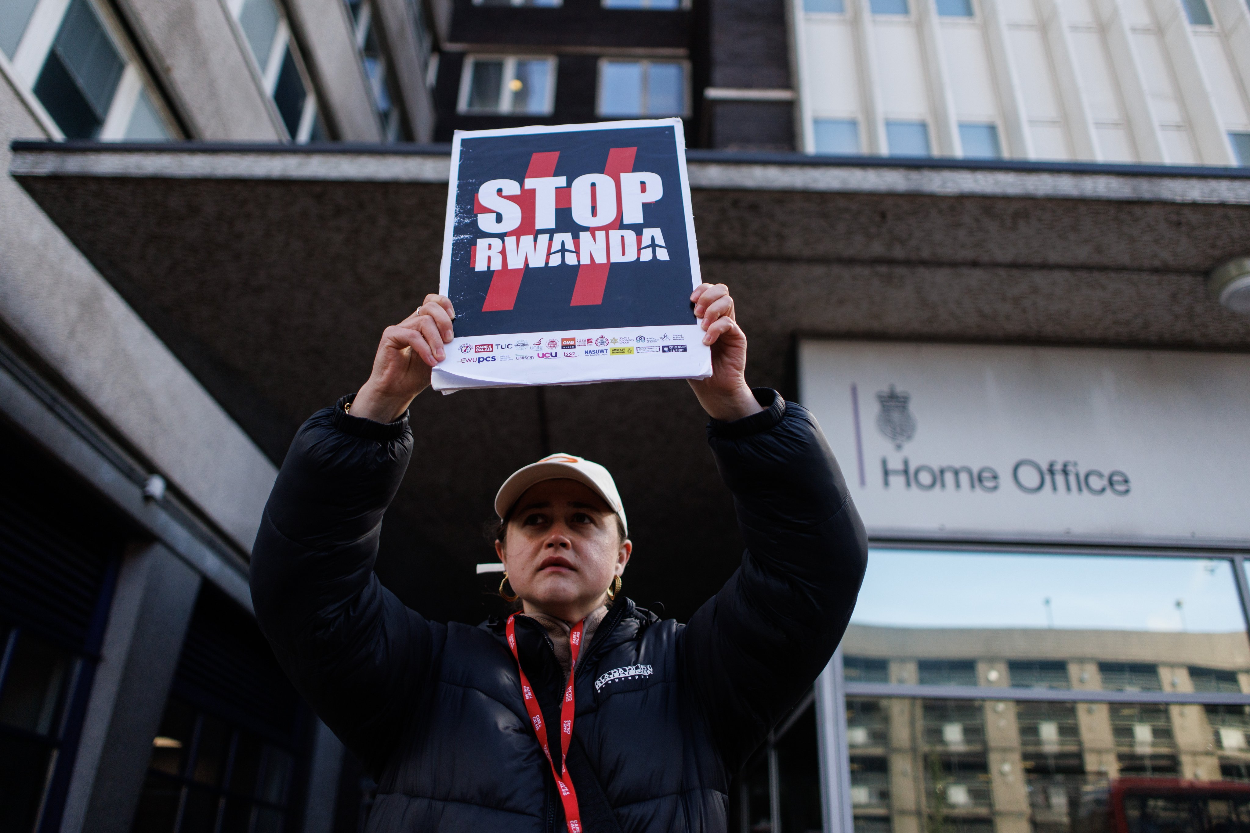 An activist protests against the British government’s Rwanda deportation scheme outside a Home Office immigration reporting centre in London on Monday. Photo: EPA-EFE