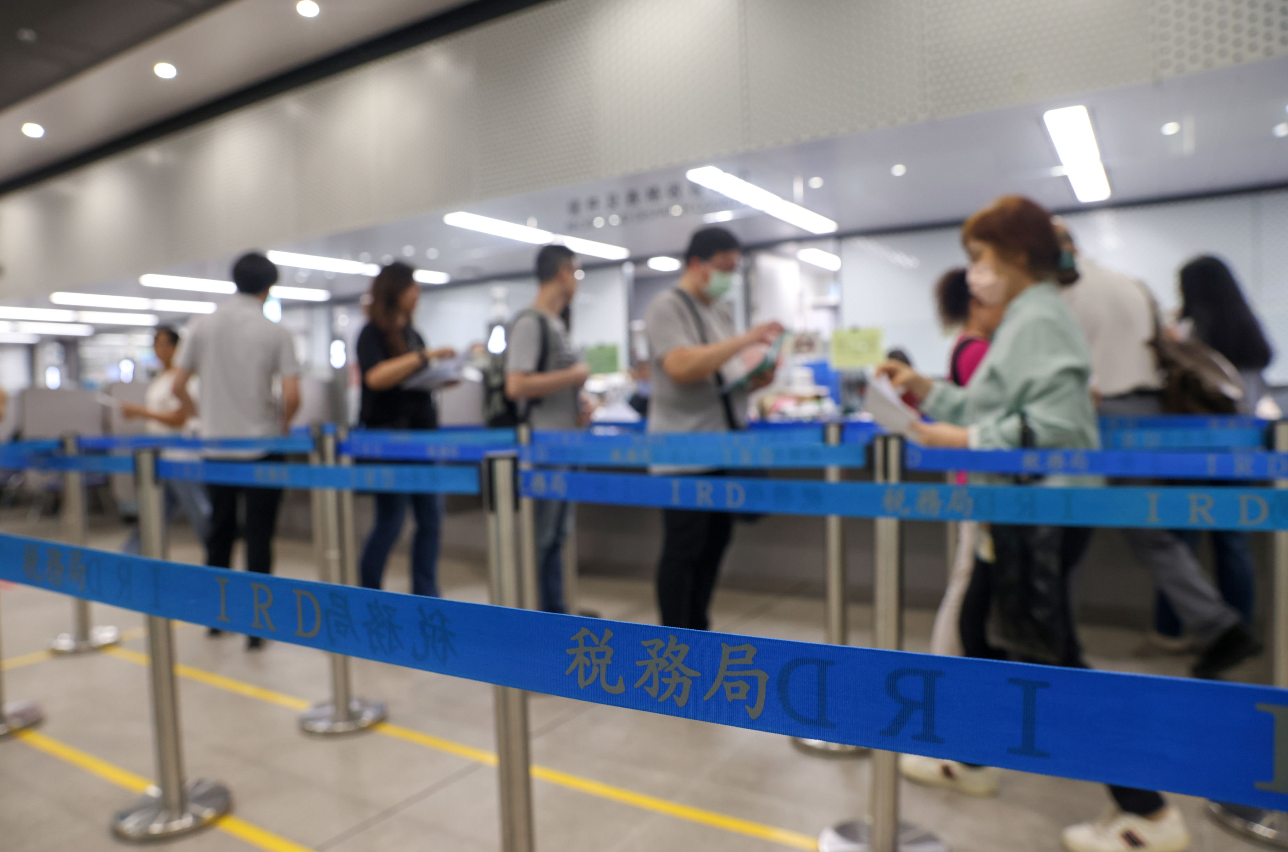 Hong Kong residents line up at the Inland Revenue Centre. Takings from profits tax, which accounted for half of the total revenue in the last financial year, declined by 2 per cent. Photo: Yik Yeung-man