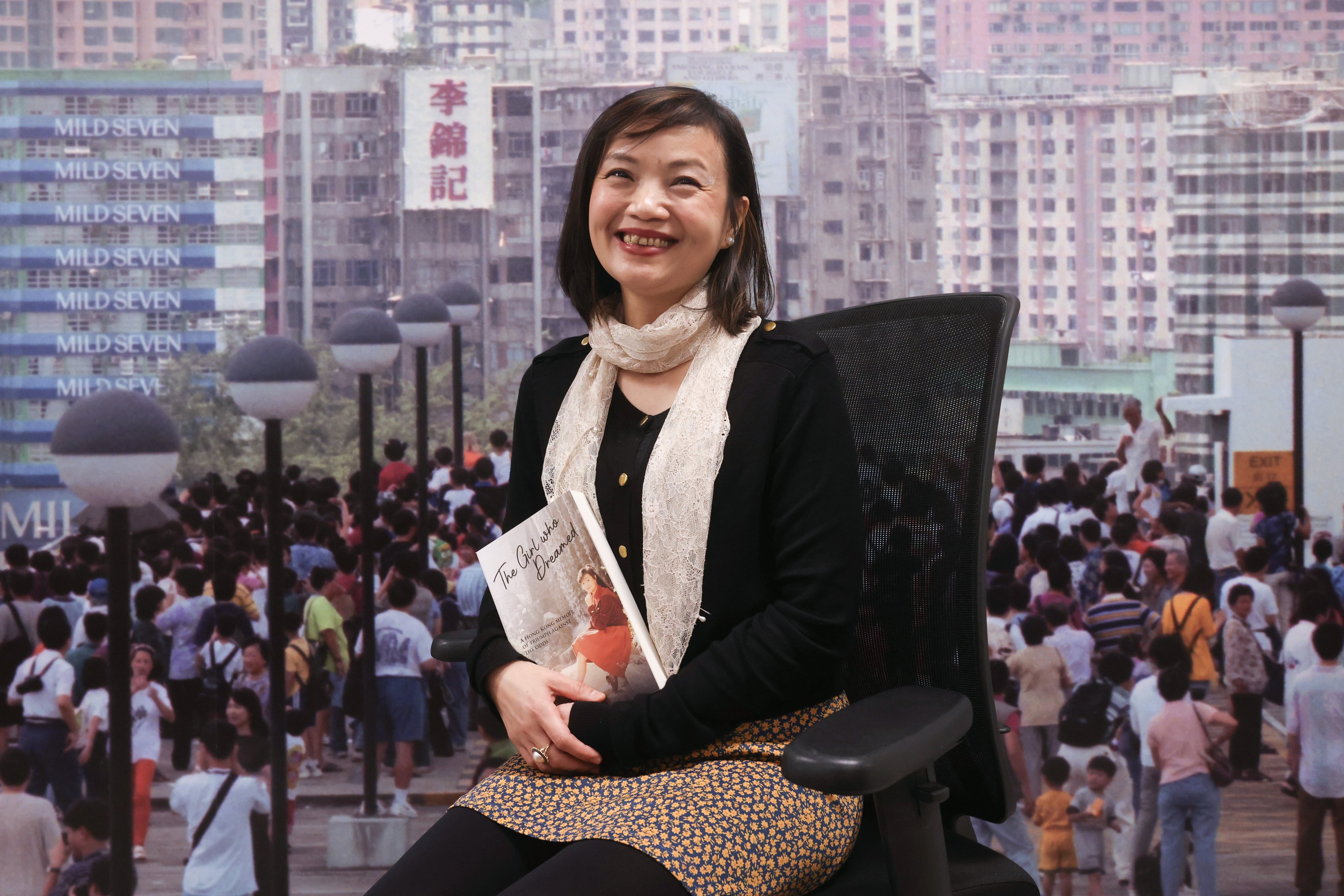 Hong Kong writer and poet Sonia Leung poses with her latest book, “The Girl Who Dreamed: A Hong Kong Memoir of Triumph Against the Odds”. Photo: Jonathan Wong