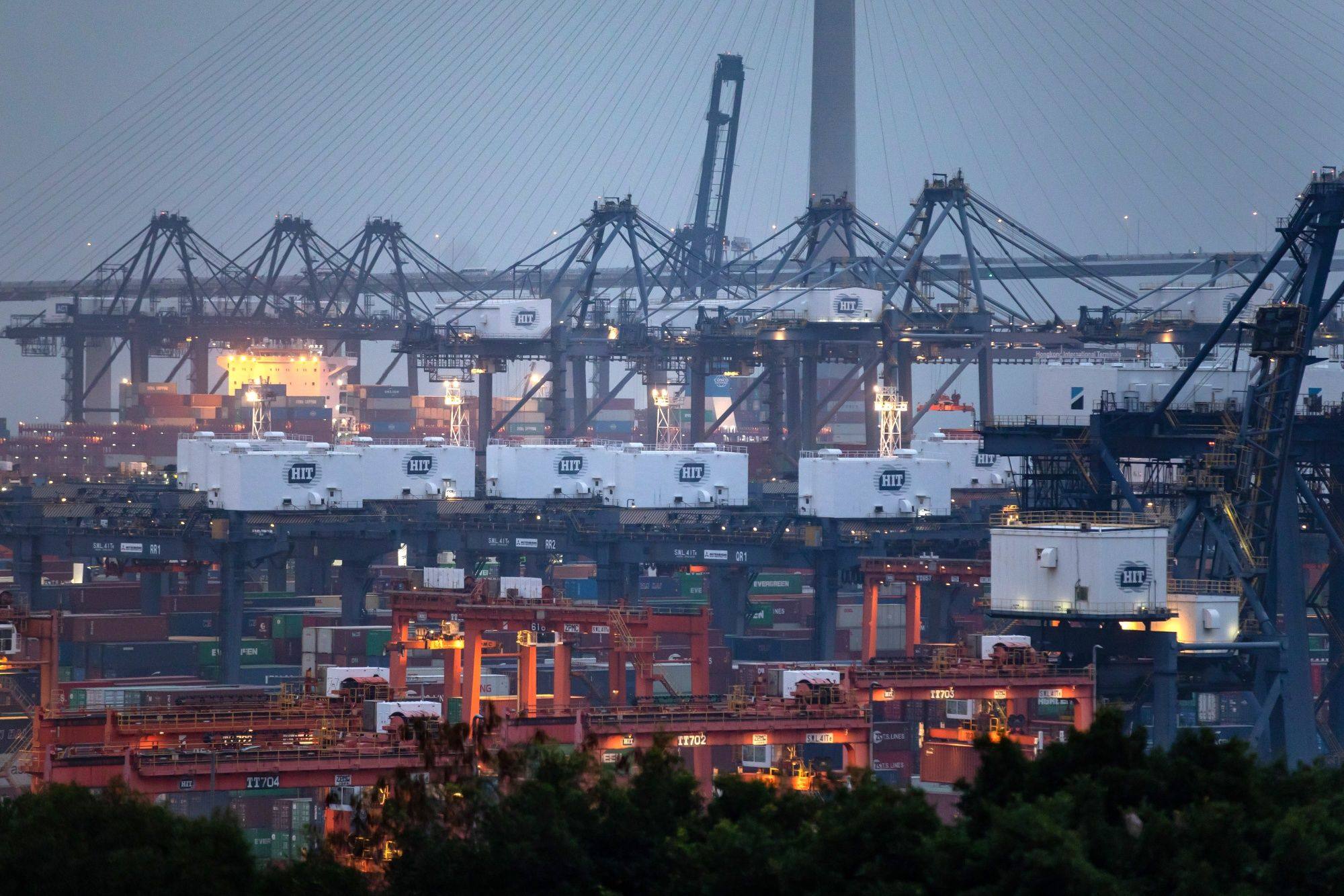 Gantry cranes are seen at dusk at the Kwai Tsing Container Terminals, in Hong Kong, on March 13, 2023. Photo: Bloomberg 