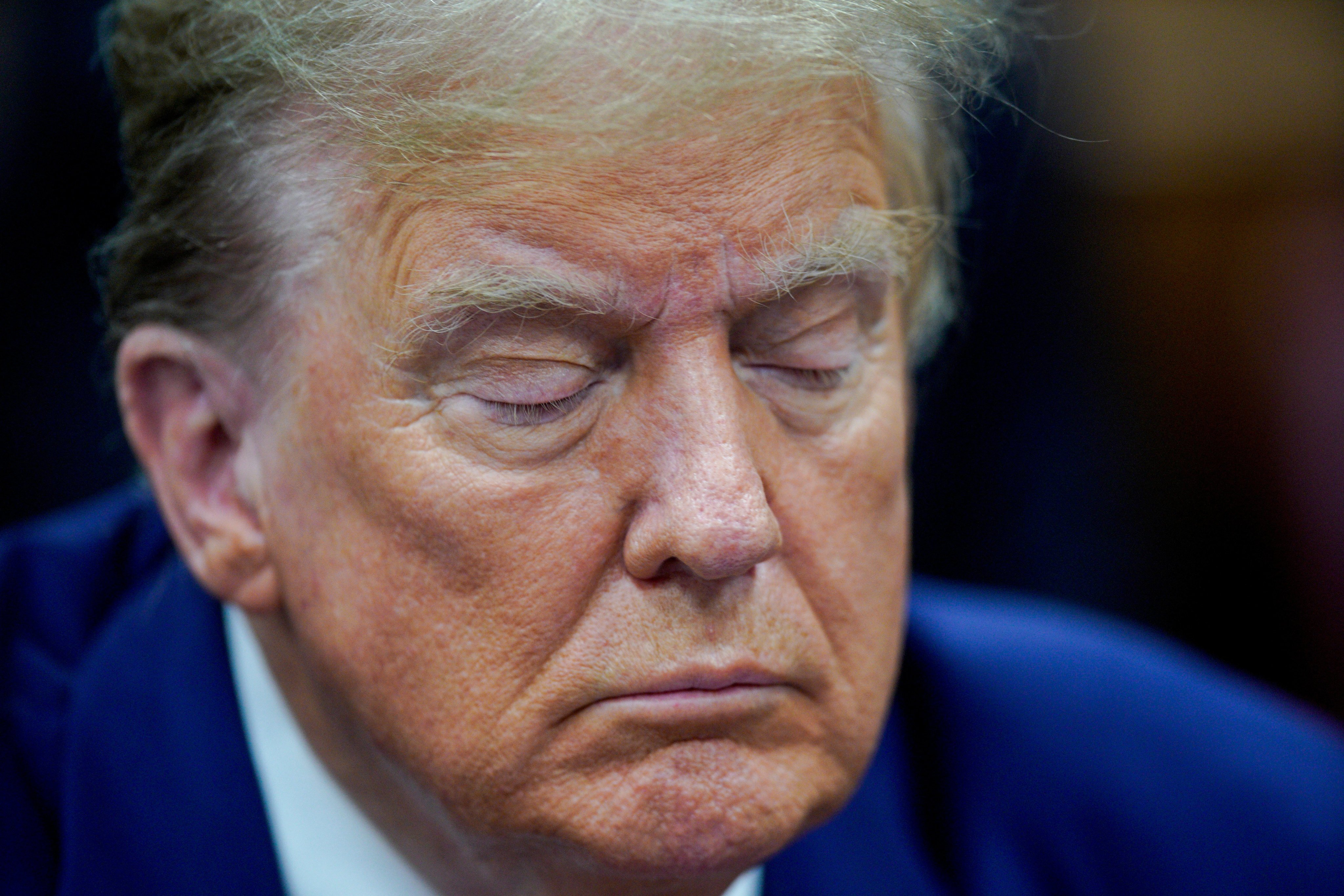 Donald Trump closing his eyes in court during his hush money trial on April 30. Photo: Reuters