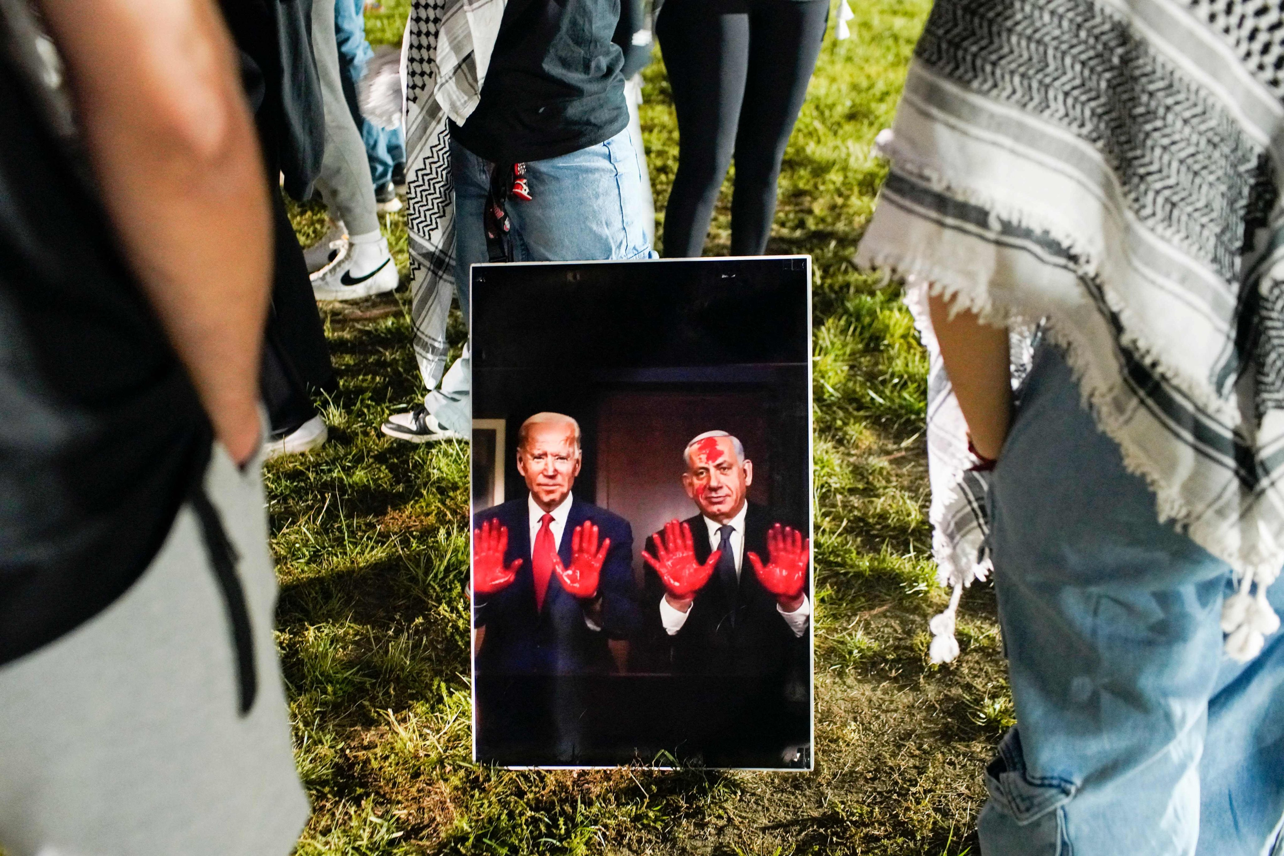 Pro-Palestinian protesters at Ohio State University in the US display a sign depicting President Joe Biden and Israeli Prime Minister Benjamin Netanyahu with blood on their hands on Wednesday. Photo: Getty Images via AFP