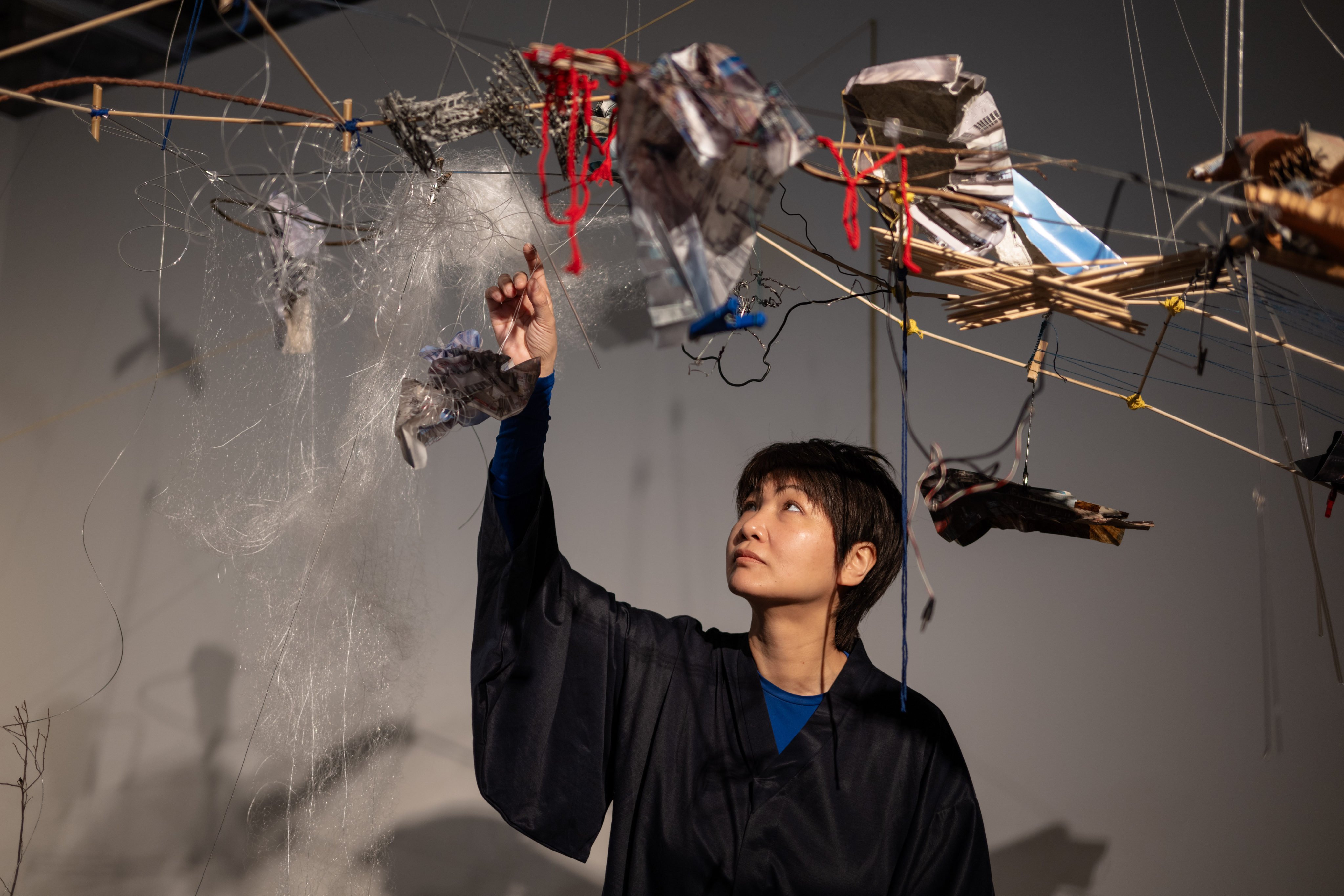Hong Kong artist Maggie Chu wth her piece Entwined Nexus – urban synapse, at Chat’s fifth-anniversary show Factory of Tomorrow. The exhibition uses works made with textiles to trace changes in Hong Kong society, and imagine its future. Photo: Chat
