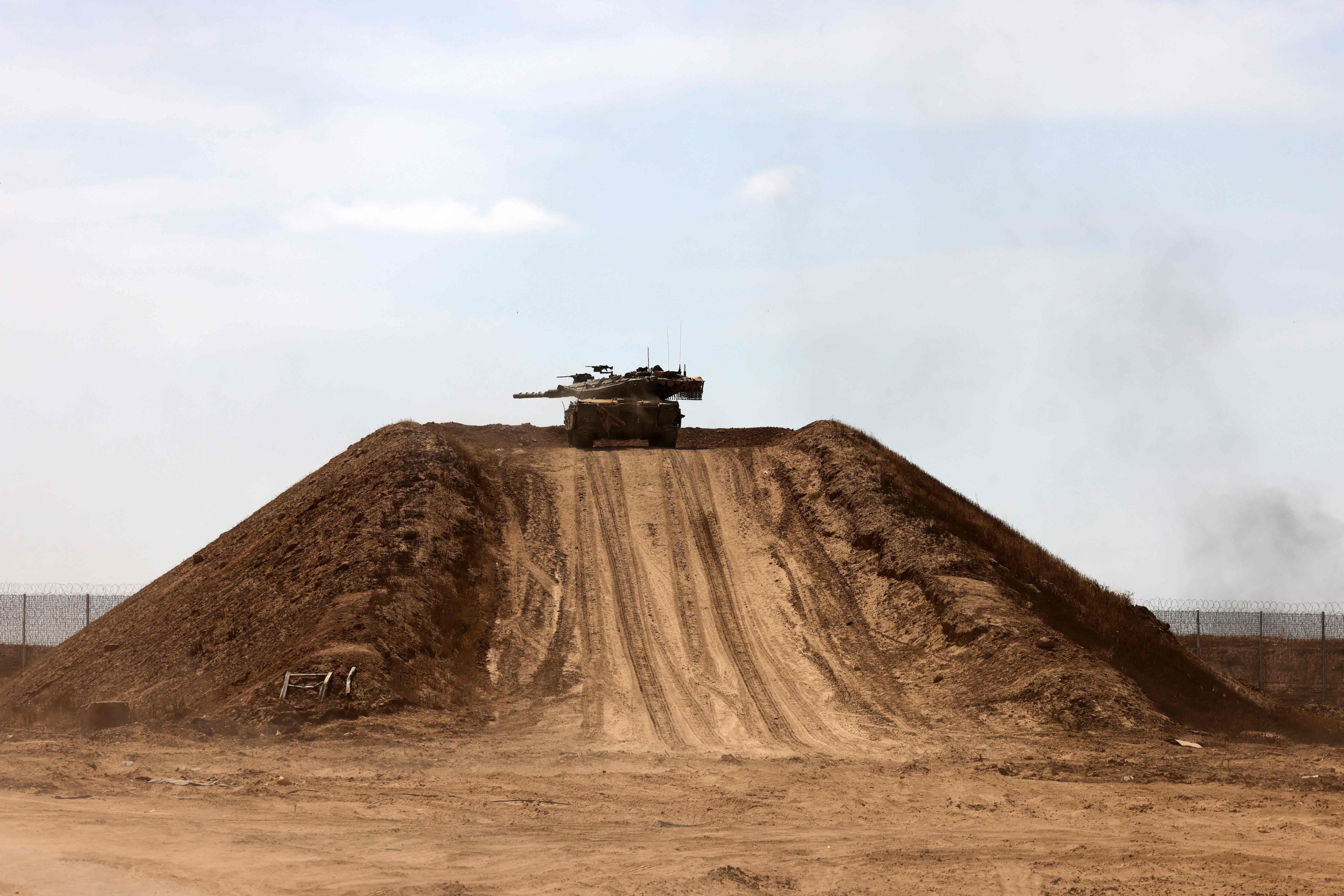 An Israeli tank atop a sand mound near the border with the Gaza Strip. Photo; AFP