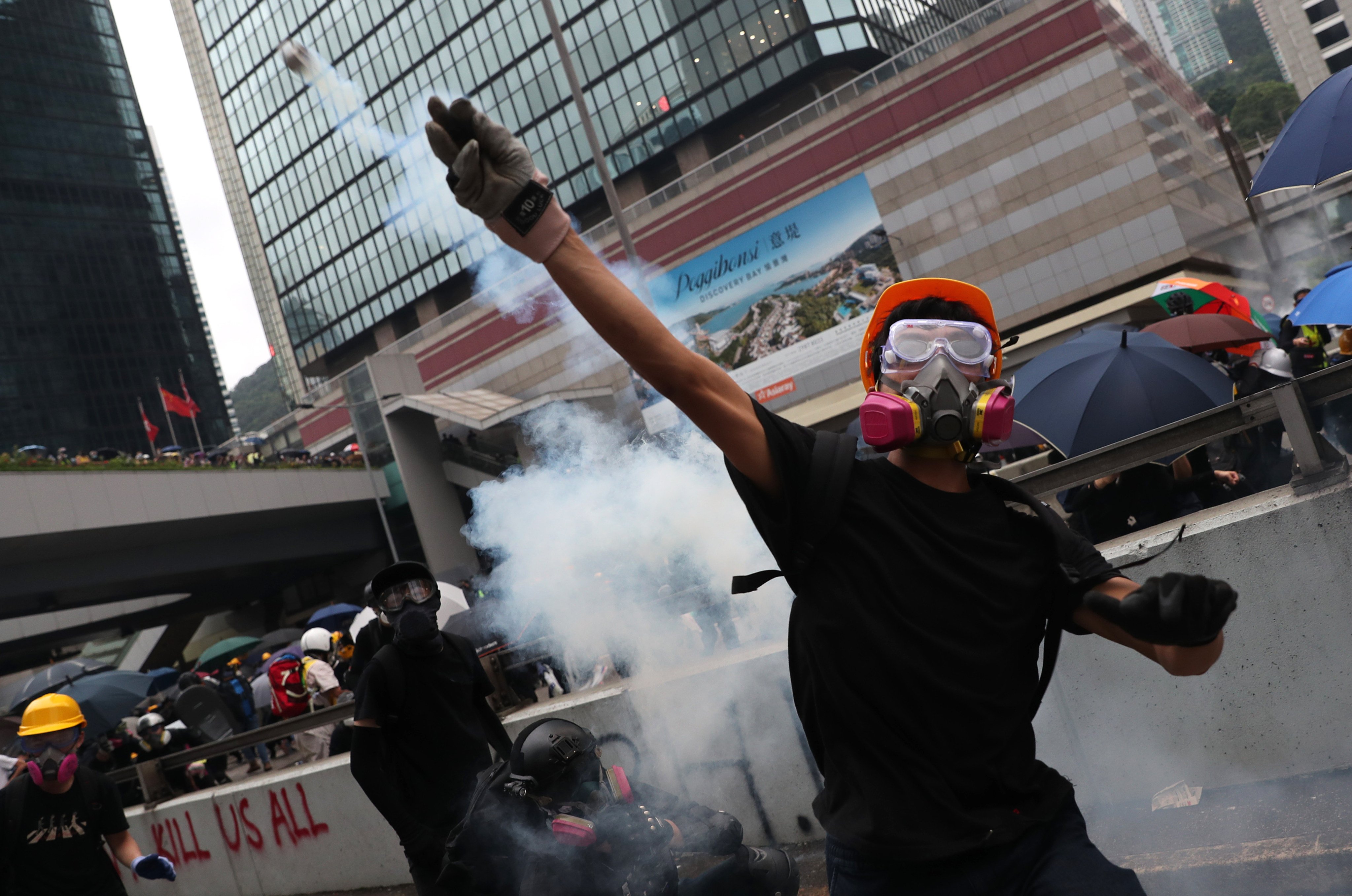An anti-government protester throws tear gas canisters back at the police in Admiralty in 2019. Photo: Sam Tsang