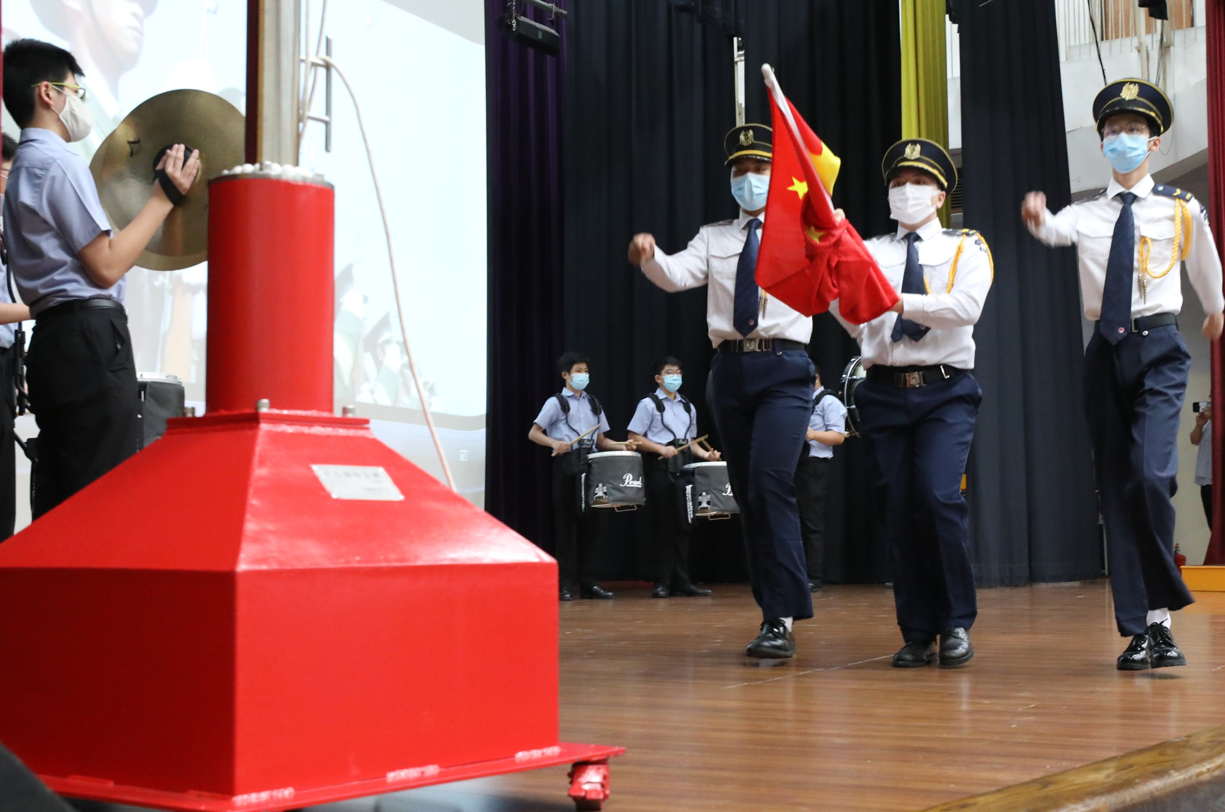 Students take part in a flag-raising ceremony at a school in Ho Man Tin on July 1, 2020. Photo: May Tse