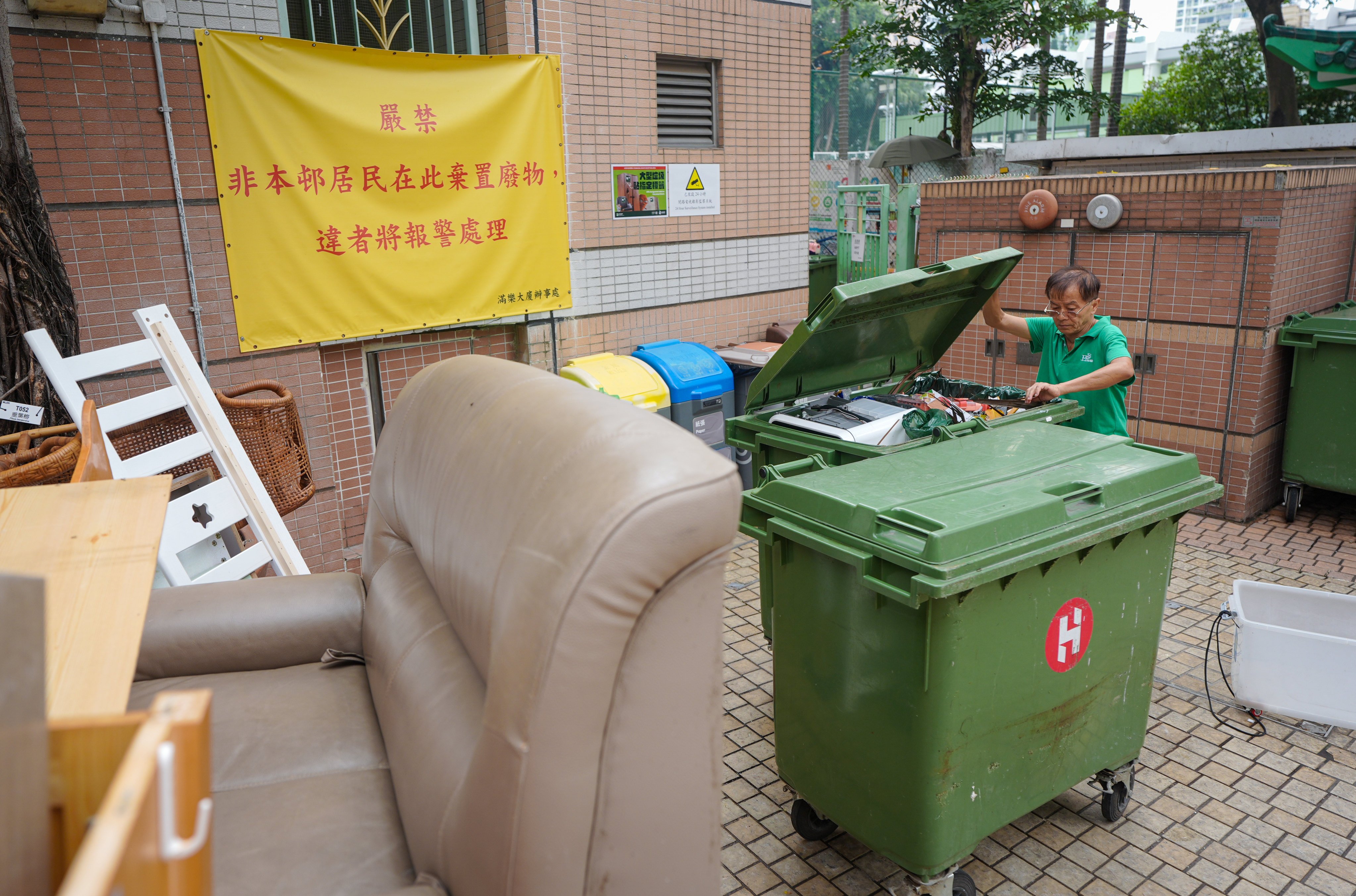 A cleaner surnamed Chung works in Moon Lok Dai Ha, a public housing estate in Tsuen Wan that is included in a trial run of Hong Kong’s waste-charging scheme. Photo: Eugene Lee