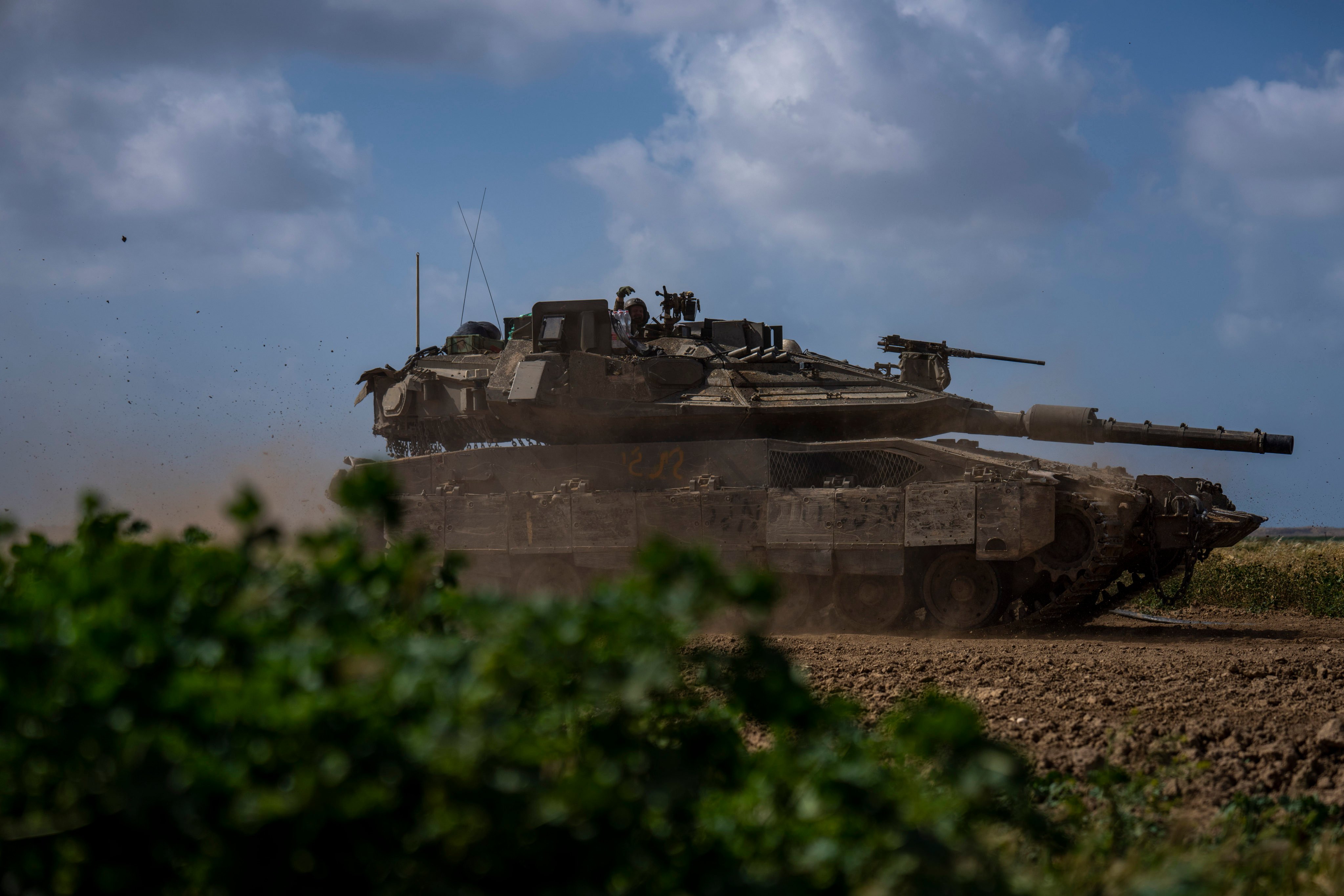 Israeli soldiers drive a tank on the border with Gaza Strip. Israel and Hamas appear to be seriously negotiating an end to the war in Gaza and the return of Israeli hostages. Photo: AP