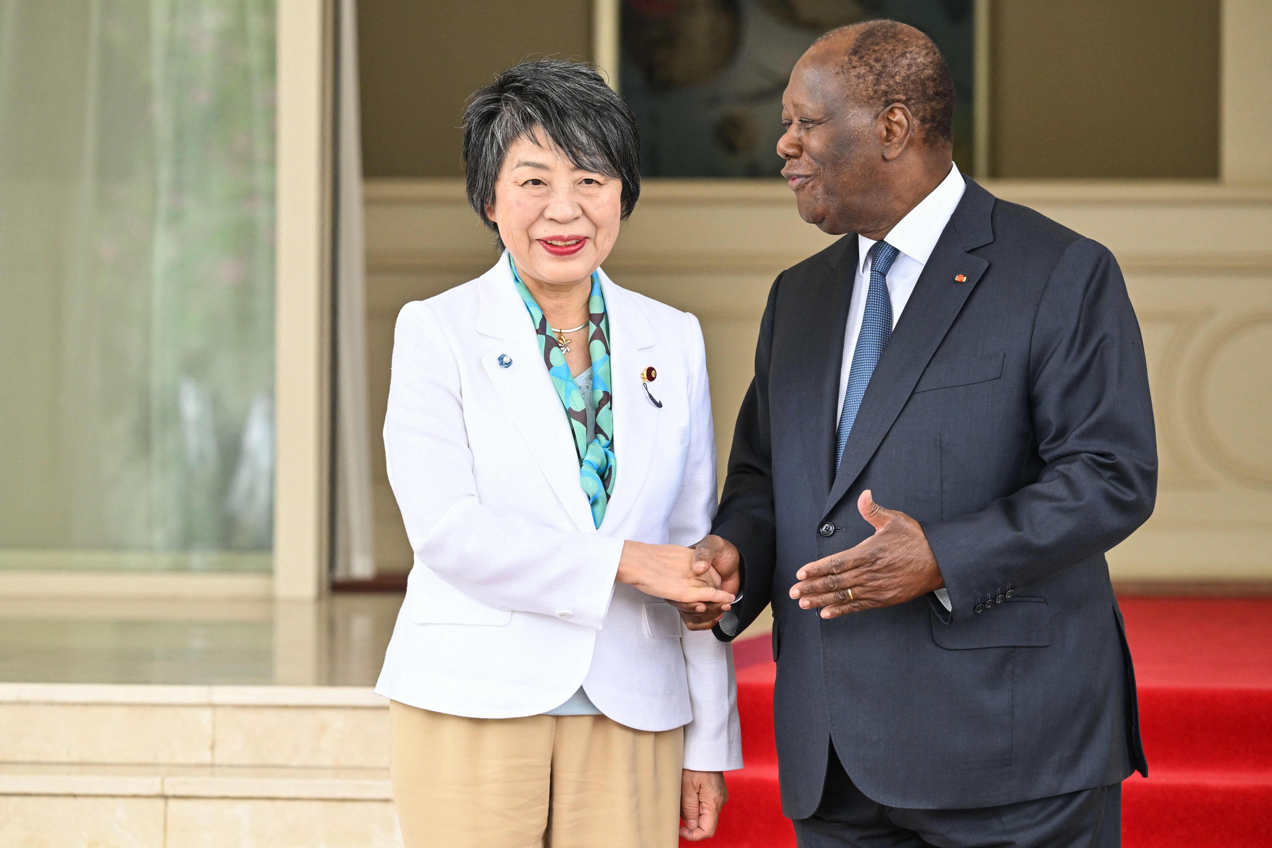 Japanese Foreign Minister Yoko Kamikawa shakes hands with Ivory Coast President Alassane Ouattara at his residence in Abidjan on Monday. Photo: AFP