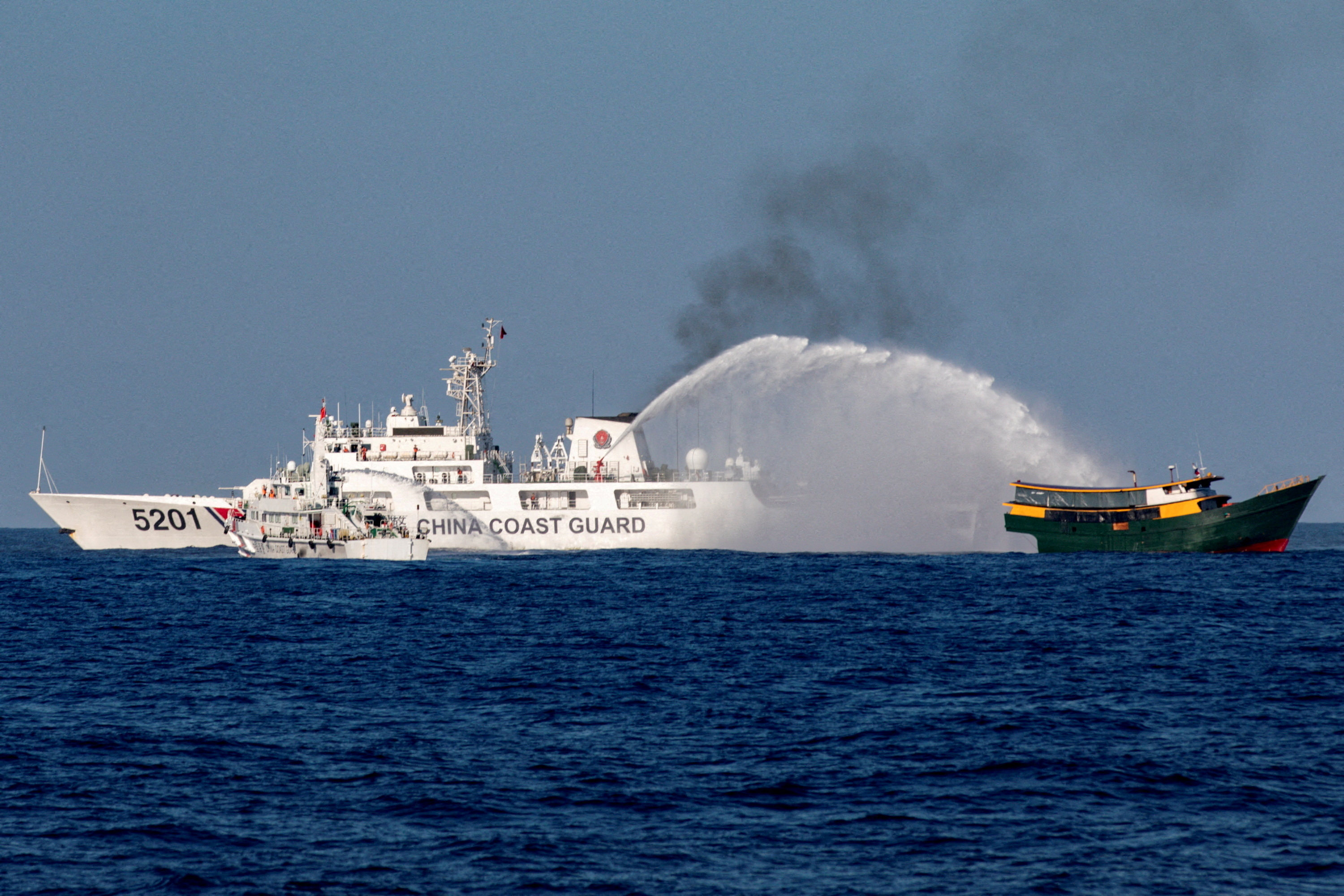 A Philippine resupply vessel en route to the  Second Thomas Shoal is hit by water cannon jets launched by the Chinese coastguard, in the South China Sea in March. Photo: Reuters  