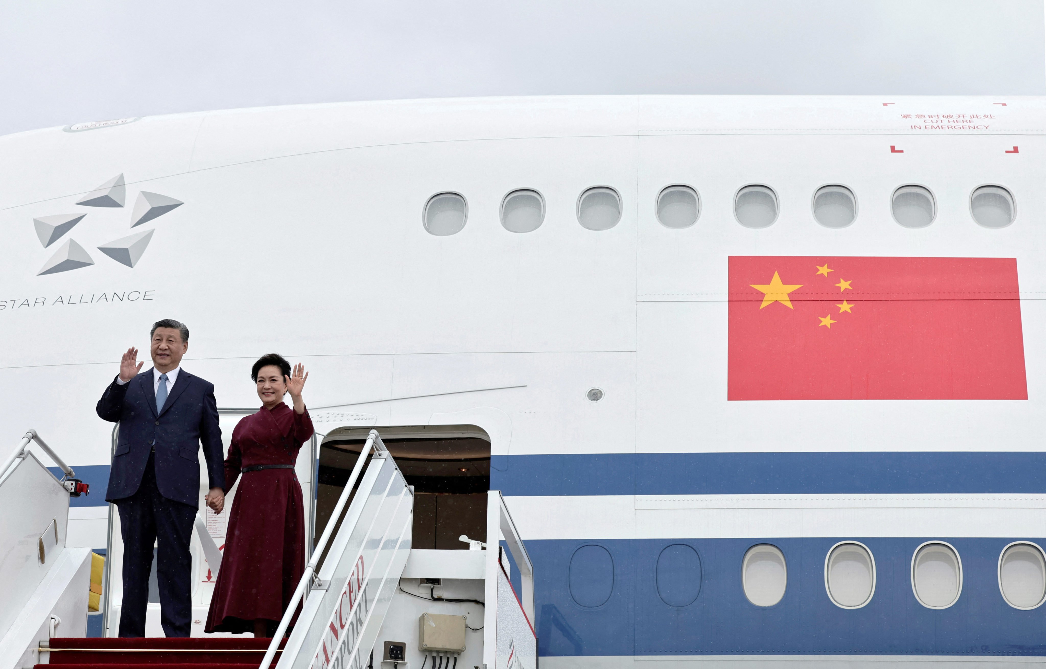 Chinese President Xi Jinping and his wife Peng Liyuan wave before disembarking from their plane at  Orly airport, south of Paris, on Sunday. Photo: Reuters