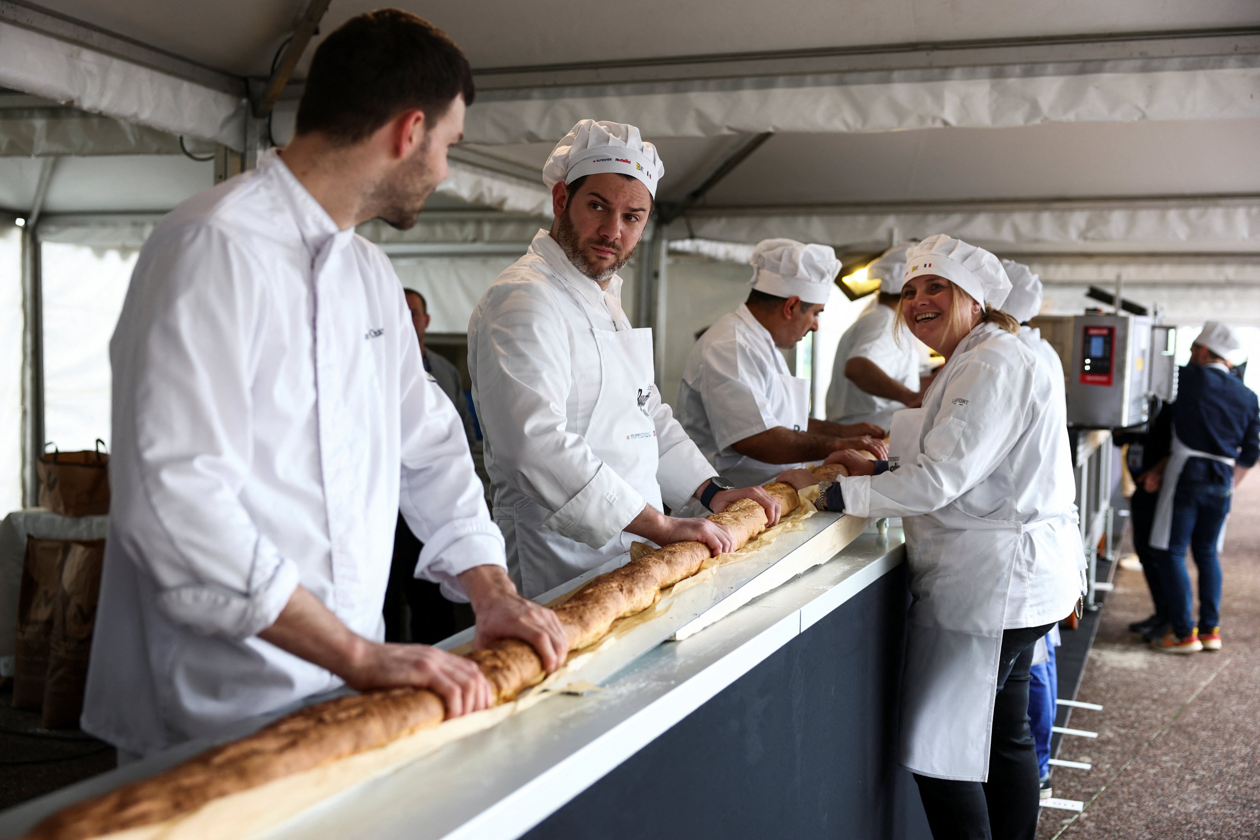 The world’s longest baguette being made in Suresnes near Paris, France on Sunday. Photo: Reuters 