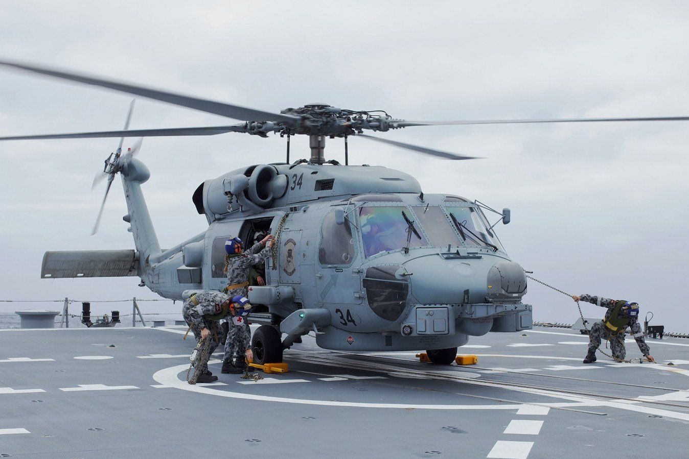 Australian sailors assigned to Australian Hobart-class air warfare destroyer HMAS Sydney (DDG 42), prepare to launch an MH-60R Sea Hawk helicopter. Photo: HMAS Sydney