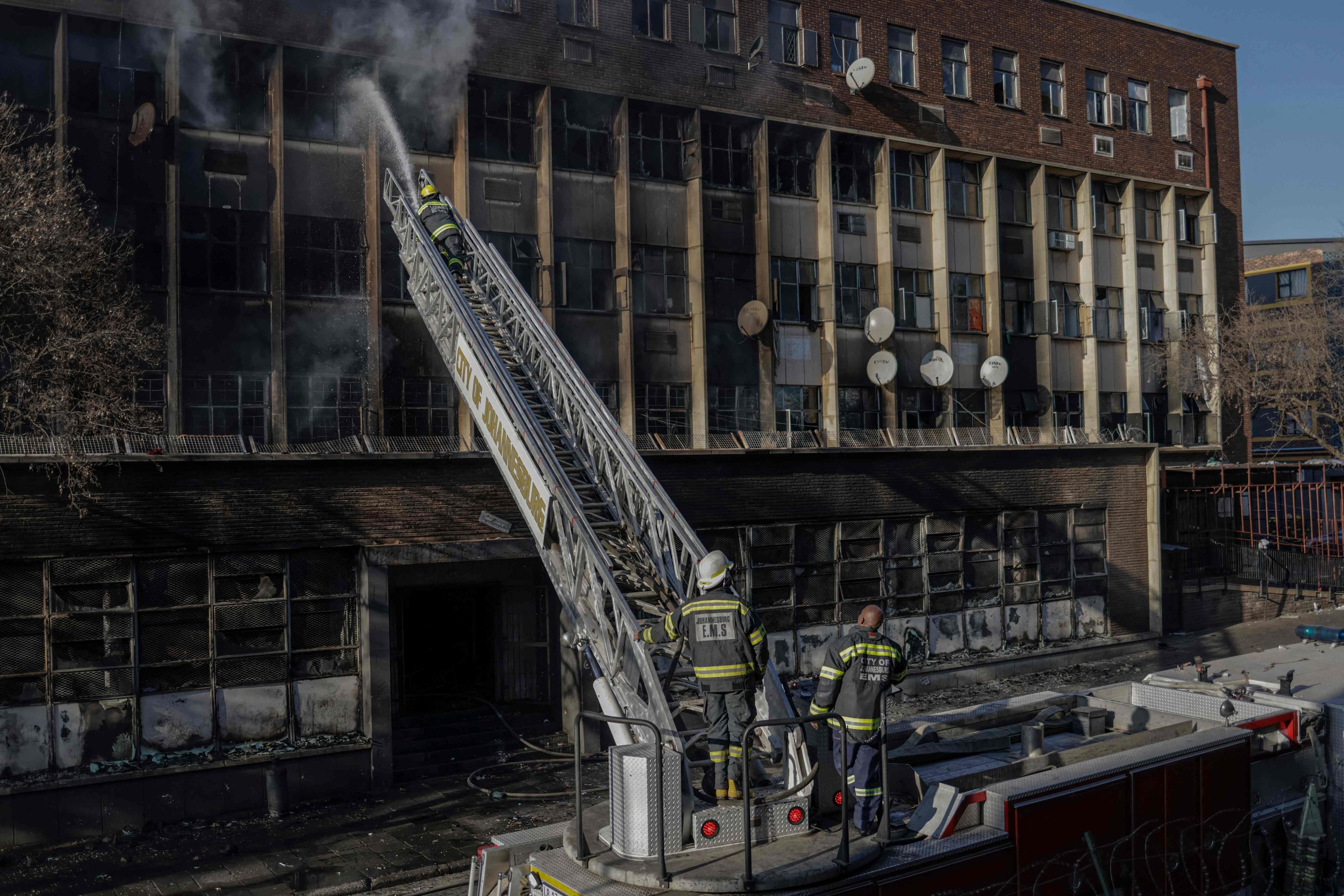 Firefighters extiguish a fire in a building in Johannesburg on August 31, 2023. Photo: AFP