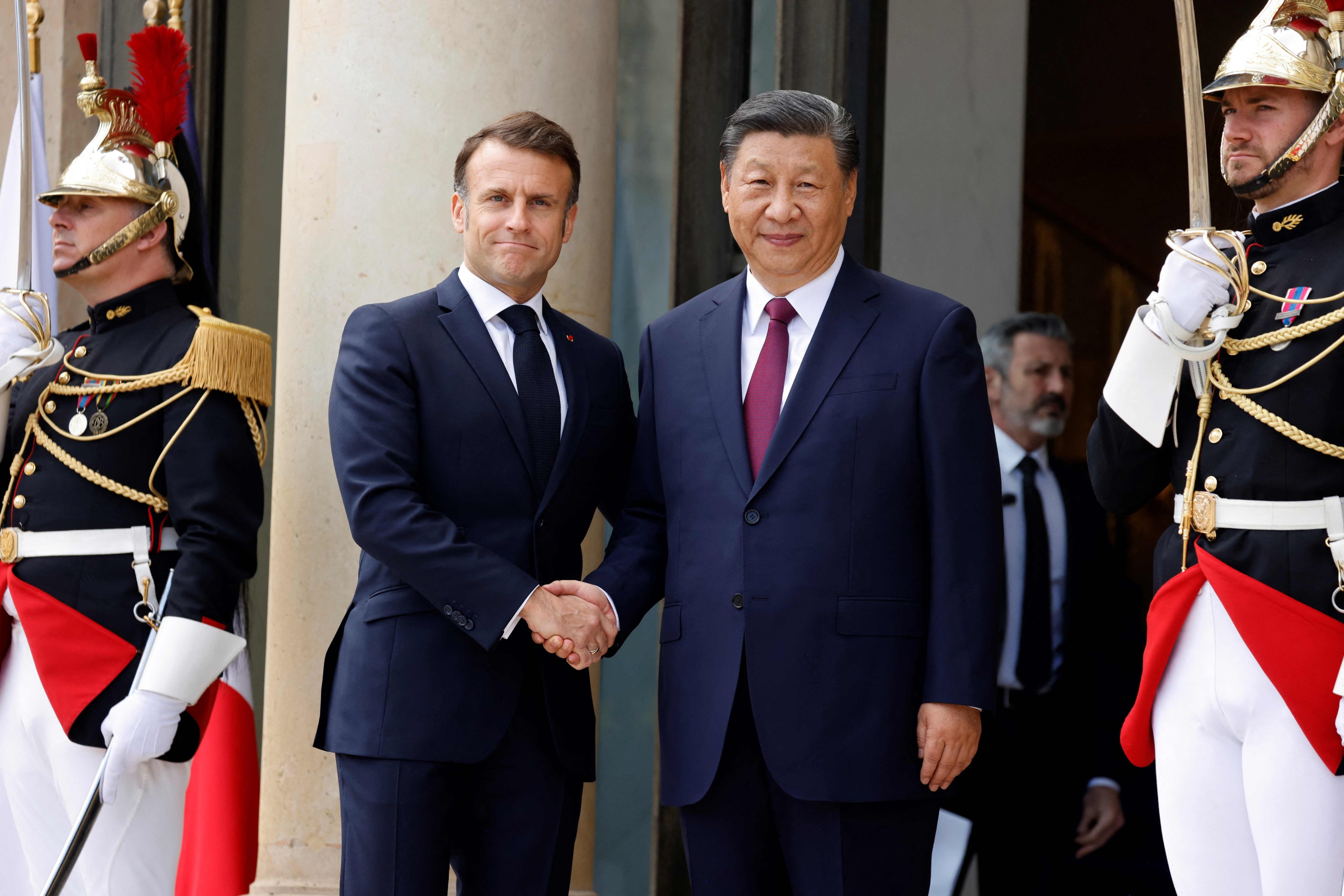 French President Emmanuel Macron welcomes his Chinese counterpart Xi Jinping to the Élysée Palace in Paris on Monday. Photo: AFP
