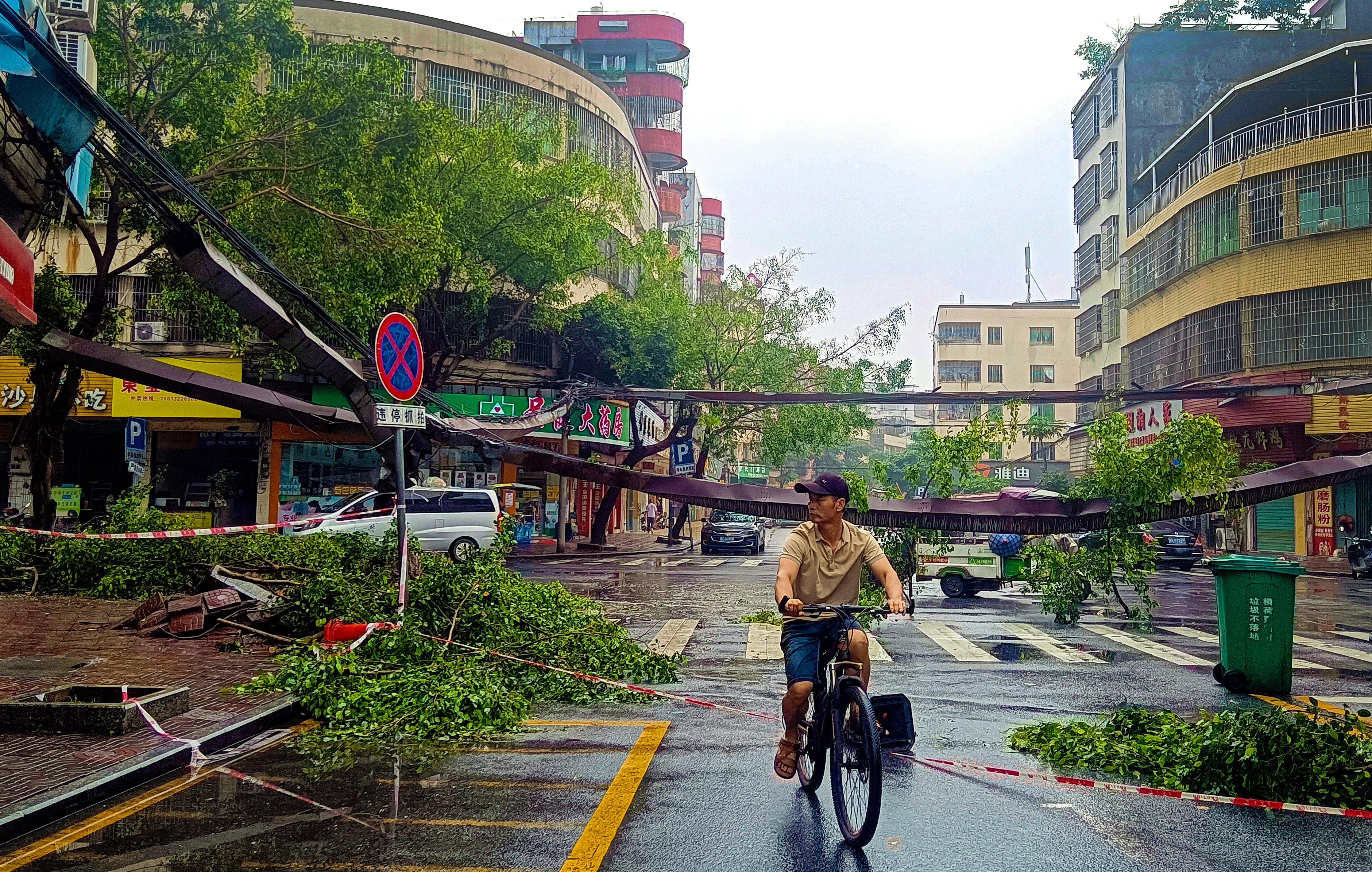 A cyclist rides past fallen debris and trees in the aftermath of heavy storms in Qingyuan city in southern China’s Guangdong province Monday, April 22, 2024. Cat bonds could help China develop a multilayer risk-transfer mechanism. Photo: AP
