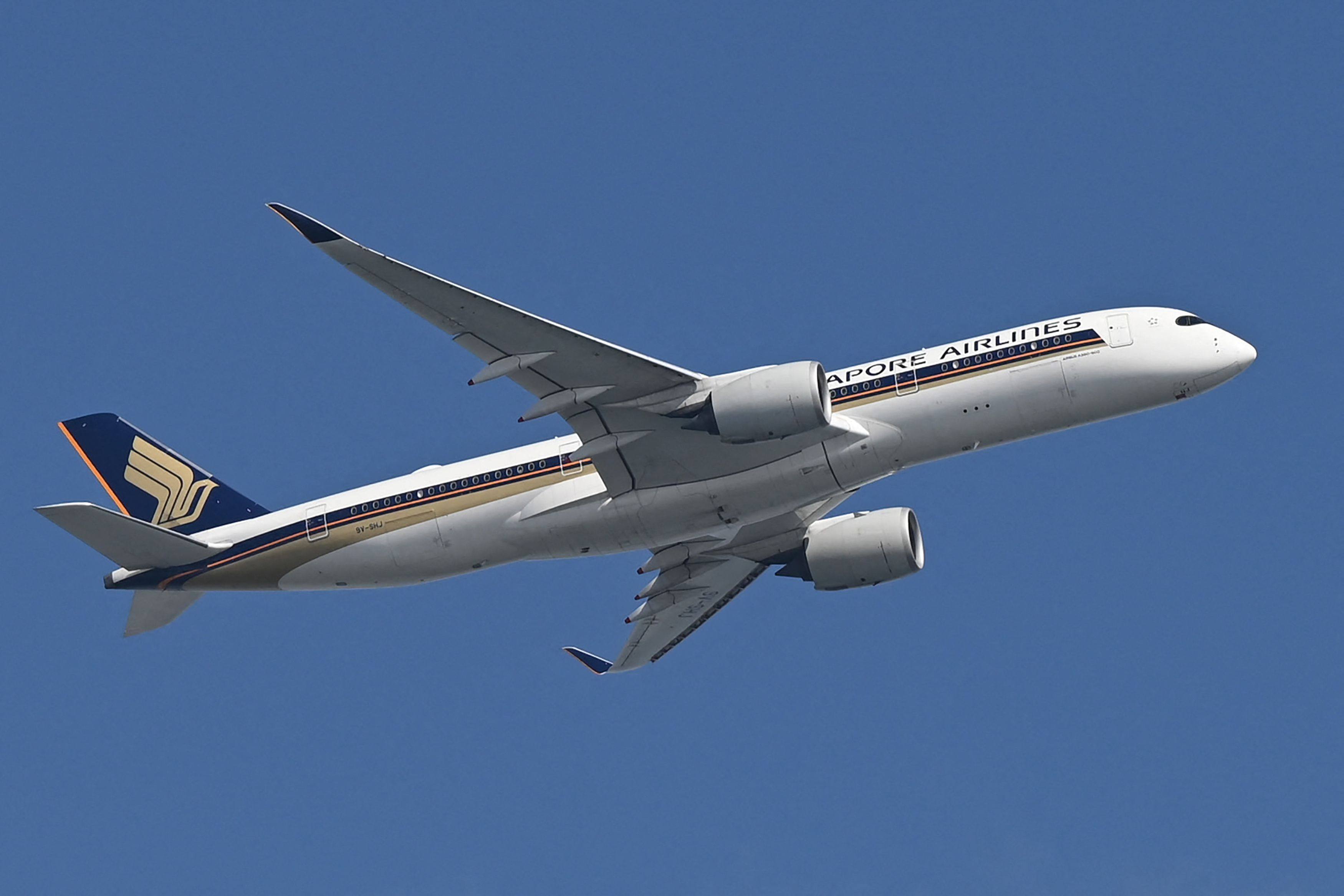 A Singapore Airlines aeroplane flies after take off from Changi Airport in Singapore on February 20. Photo: AFP