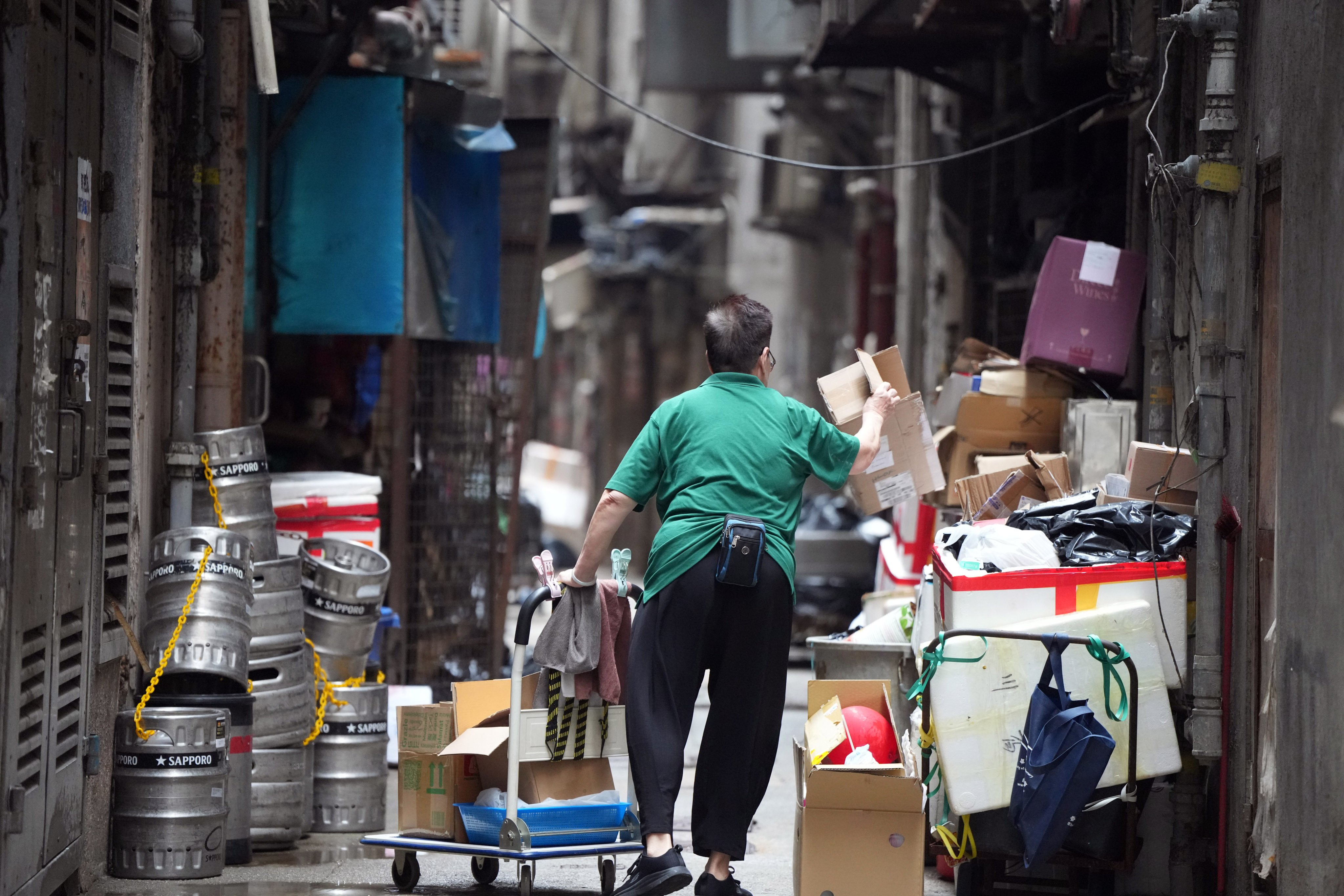 A cleaner working in a back alley in Hong Kong’s Wan Chai district on April 29. Hong Kong should support cleaners’ work by giving them the space and facilities needed to collect, separate and sell recyclable material. Photo: Sam Tsang