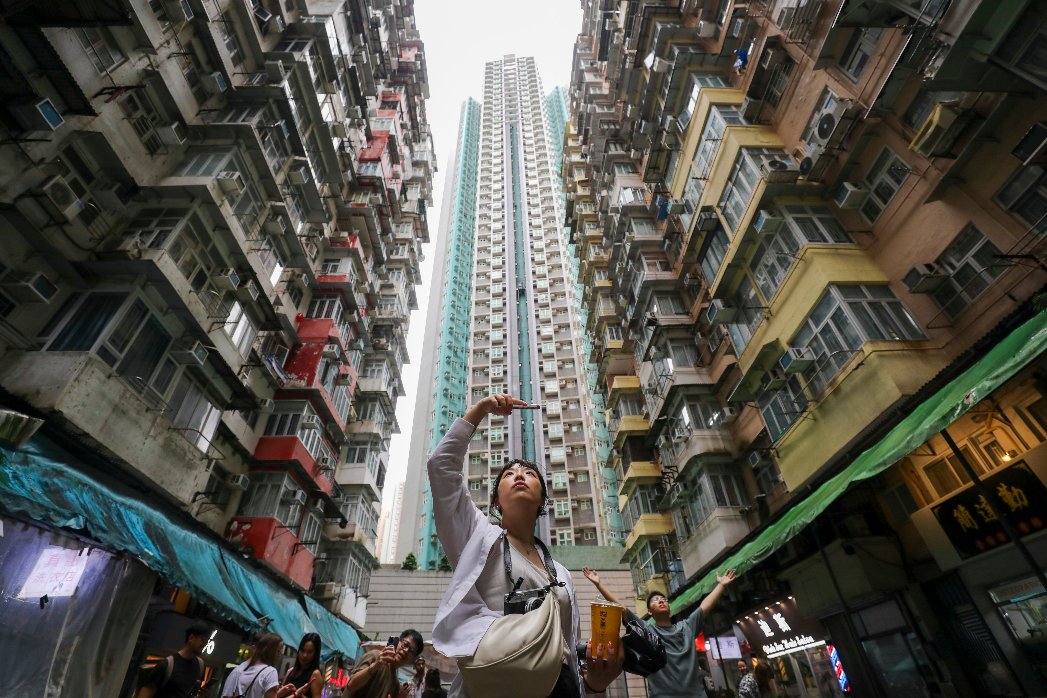 Tourists take pictures at Yick Cheong Building, also known as ‘monster building’, in Quarry Bay. Photo: Xiaomei Chen