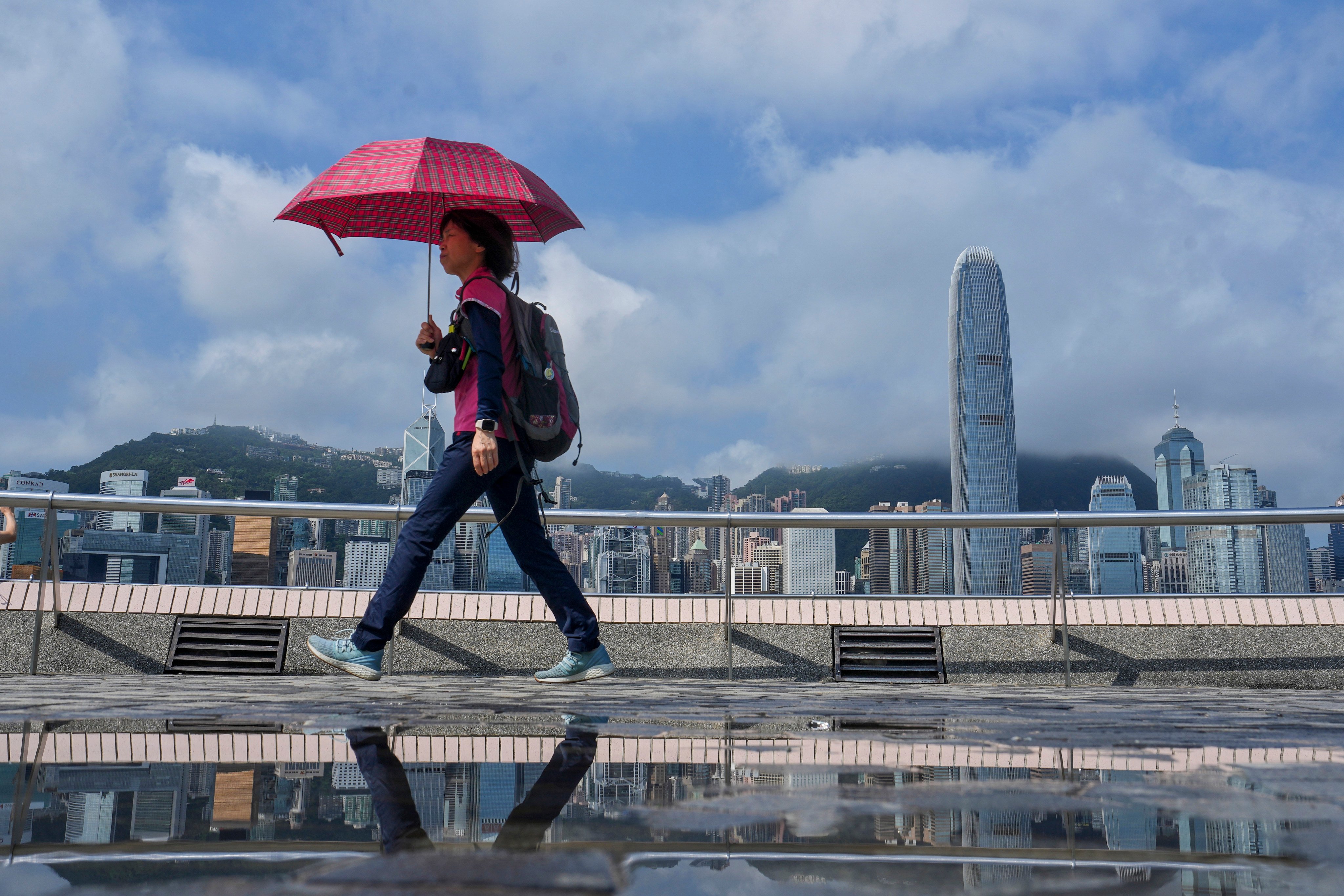 A tourist takes a stroll along the Tsim Sha Tsui promenade during the Labour Day golden week break. Photo: Elson Li